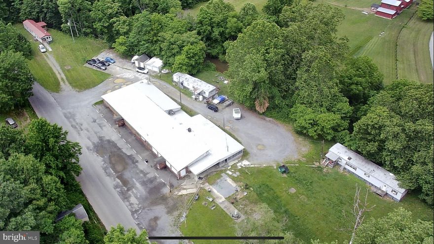 Have you been looking for a property that you could do something amazing with...with lots of potential, AND some income producing rentals?  I have just the place for you!  This commercial building is situated on over 2  unrestricted acres and is less than a mile from Route 9.  The building measures over 7000 sq. ft. including 2 bars, outdoor seating area, full kitchen with equipment , New freezer and prep bar bought about 4 years ago, all new lighting installed in front bar, a walk-in cooler and lots more!  There is plenty of space to expand into the outdoor area and as a BONUS, it comes with 3 income producing tenants.  There are  3 mobile homes on the property, 2 are owned, 1 lot rent with total income of $1025/month, current tenants are good tenants.  Make an appointment to see the potential in this place!  Buyer to perform due diligence.