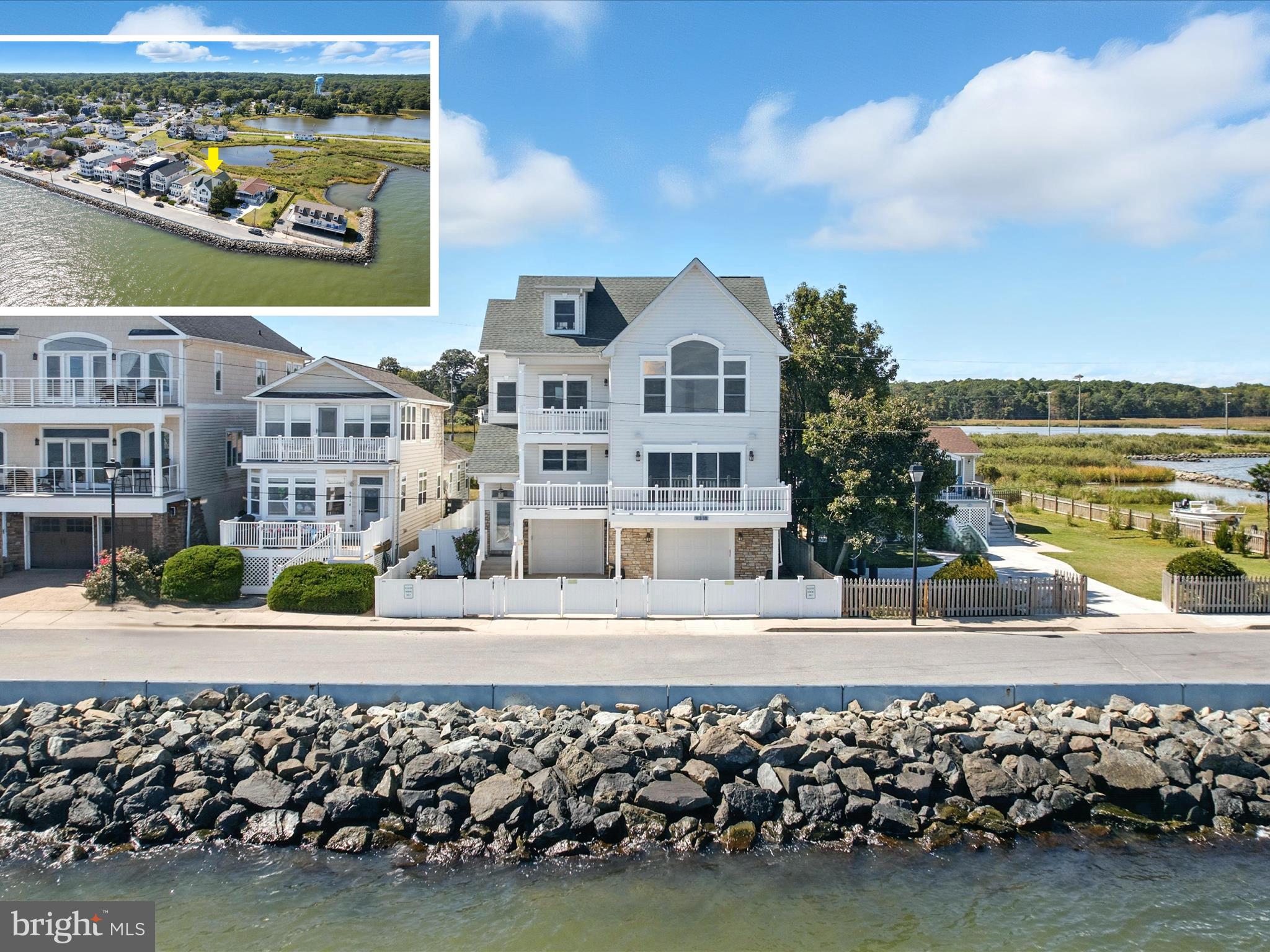 Perched on three expansive lots with prime frontage, this North Beach home offers breathtaking water views from nearly every window and multiple decks overlooking the Chesapeake Bay. Refinished hardwood floors in a light tone with both warm and cool graining complement the freshly painted interiors, while design-inspired tile and finishes elevate every renovated bathroom. Modern updates include recessed lighting throughout, new ceiling fans in all bedrooms, replaced light fixtures, a refaced fireplace, and a new heat pump, alongside thoughtful structural improvements such as the removal of a wall to open the staircases on the second and third floors. Recently featured in the Washingtonian June 2024 "Water's Edge" article, this home radiates sophistication and coastal charm.
The recently updated kitchen shines with quartz countertops, a glass tile backsplash, stainless steel appliances, a gas range, and built-in speakers. The open-concept main level flows effortlessly, with a large kitchen bar providing additional seating ideal for entertaining. In the living room, expansive Chesapeake Bay vistas lead to a deck perfect for enjoying the water views and the soothing sound of waves lapping against the rocks, while the dining area enjoys the same scenery, anchored by an elevated peninsula gas fireplace shared with the living room and kitchen. Step outside from the spacious family room, where vaulted ceilings and walls of glass-paneled doors with sidelights fill the space with abundant natural light and lead to a deck with views over the wetlands, complete with surround sound speakers. The main level also includes a generously sized laundry room with coordinated floor and wall tile, and a versatile space that can serve as a water-view office or bedroom, featuring a full bath, and walk-in closet.
Upstairs, the primary suite impresses with a cathedral ceiling, panoramic water views, a walk-in closet, and a private balcony. The en suite bath offers a soaking tub, double vanity, and a tiled shower, with water views appreciated from the bathroom itself. Two additional bedrooms with walk-in closets share a full bath with a double sink vanity. On the third floor, a spacious bedroom enjoys water views from every window and a window seat, accompanied by another dual-entry full bath and a sixth bedroom overlooking the wetlands. Outside, a generous fenced yard with a back gate provides direct access to kayak launching spots. Parking is abundant, with a four-car tandem garage and a concrete fenced driveway accommodating two more vehicles for a total of six spaces.
Located in the heart of North Beach, residents have easy access to shops, restaurants, and community events, including farmer’s markets and concerts, as well as the boardwalk, pier, and sandy beach just steps from home. Whether seeking a year-round residence or a coastal getaway, this retreat, only 45 minutes from DC, offers the perfect blend of comfort and convenience. Park your boat at Herrington Harbor Marina or Rod & Reel Resort. Experience a vibrant coastal lifestyle with a charming boardwalk, seasonal farmers market, Bayside History Museum, parks and nature preserves, a brand-new library, cultural events, and welcoming gathering spaces. This North Beach home captures the essence of small-town charm while offering the modern comforts and breathtaking views of the Chesapeake Bay.