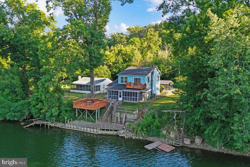 OFFER DEADLINE:   SATURDAY JULY 6th at 8pm.  NO ESCALATIONS.  OPEN HOUSE:  SATURDAY JULY 6th 12pm - 2pm.  C'mon out to the rivah!!  This is your chance to own one of the largest riverfront homes on the Shenandoah River.  Enjoy kayaking, swimming, fishing, paddleboarding, jet-skiing, and power boating, as this part of the river is deep enough for boat craft.  This beautiful home is move-in ready with 2475 above grade square feet, 2.5 baths, and 4 bedrooms.  The primary bedroom is upstairs, has its own private deck, and overlooks the scenic river (please check out all of the stunning aerial photos!).  Many new updates within the last few years:  Septic System has been inspected (June '24) and a new Distribution Box and Lines have been installed; New Stainless Steel Refrigerator; New A/C - Gas Furnace downstairs; New A/C Heat Pump/Air Handler with Blue Heat upstairs; New Instant-Hot Hot Water Heater; New Whole House Generator Interlock; Main level Full Bath has a renovated Walk-in Shower; Renovated Screened-In Porch;  New Sidewalk, Shed, and Carport.  Other wonderful features:  Thermostatically Controlled Pellet Stove on the main level and ample storage in the upper attic.  Recent Exterior Power Washing, and Professionally Cleaned Carpets.  There is not an official HOA, but there is a Civic Association in the community which charges an annual fee of $400 for road maintenance, and the upkeep of the community's private boat ramp and community lot.  Boat Ramp Keys are $50/year.  Selling AS-IS.  The owner will also entertain a separate sale for his custom made Pontoon Boat which has less than 20 hours on the river.  Don't lose this opportunity to spend quality time with your family and friends in this lovely cottage.  The possibilities are endless!!  Come see me during the Open House Events.  I look forward to showing you this lovely home!