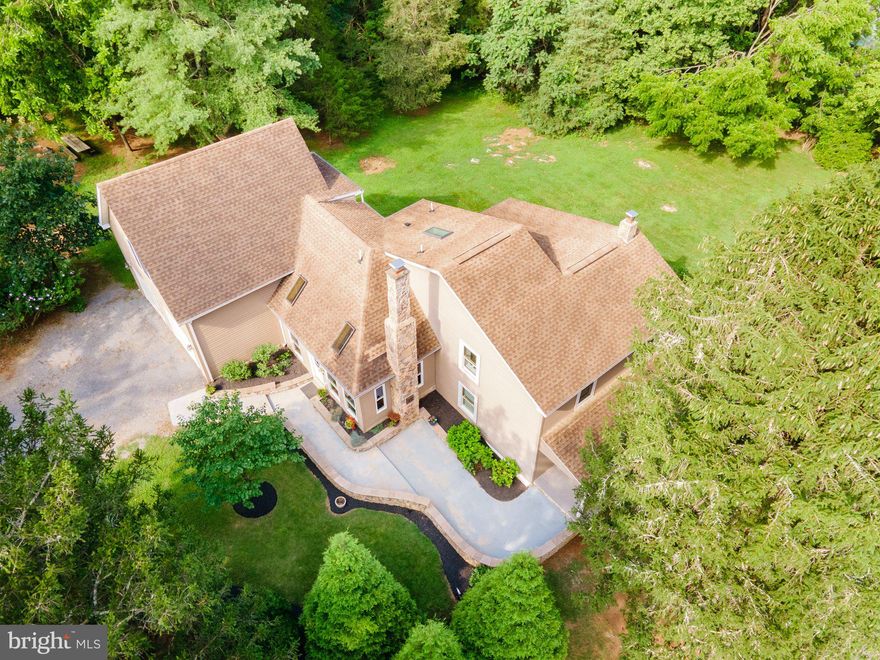 Refreshed, Reimagined & Ready to Welcome You Home

Originally constructed as a rustic log cabin, this beautifully expanded and updated property blends historic charm with modern comfort, all nestled on over 3.5 acres of park-like land just outside Shepherdstown, WV. Mature trees, thoughtfully landscaped gardens, and gently rolling lawn create a peaceful, private setting—ideal for those who value serenity, creativity, and connection to nature.

Located directly across from the Izaak Walton League, this property offers opportunity to enjoy one of the area’s most scenic and wildlife-rich preserves—perfect for nature walks, birdwatching, and outdoor recreation. And for commuters, the location couldn’t be more ideal: just 10 minutes from historic downtown Shepherdstown, and under 30 minutes to the MARC train in Harpers Ferry for easy access to Northern Virginia and Washington, DC. Routes 340, 9, and I-70/I-270 are all within close reach.

Inside, part of the home retains its original log cabin character with hand-hewn beams and timeless wood detailing, while a series of thoughtful additions have elevated the space for today’s living. One of the most exceptional features is a 27’ x 22’ custom-designed room, originally built as a personal office and writing sanctuary. With soaring ceilings, hardwood floors, and abundant natural light, this inspiring space has been staged as a luxurious primary suite—complete with custom built-ins and a peaceful, spa-like ambiance. If this were to be used as a bedroom, there are two other spaces that could be offices, flex rooms, bedrooms. (Septic is only rated for 2 Bedrooms).

Just down the hall, the spacious bathroom offers a whirlpool tub, walk-in tiled shower, and a skylight that fills the room with natural light. The kitchen features white cabinetry, updated appliances, and a casual dining area, while the adjacent formal dining room showcases heart pine floors and charming arched doorways. Additional living spaces include a sunroom, cozy gathering areas, and a sizable two car garage.

Recent updates include fresh interior paint and updated landscaping—making the home move-in ready.

Whether you're looking for a private creative retreat, a commuter-friendly residence, or a home with historic charm and wooded beauty, this distinctive property delivers. With nearby access to the Potomac River, the C&O Canal Towpath, Antietam Battlefield, and Shepherdstown’s shops, restaurants, and campus life, the location offers the perfect blend of convenience and escape.

Schedule your private showing today to experience the setting, space, and story this home has to offer.