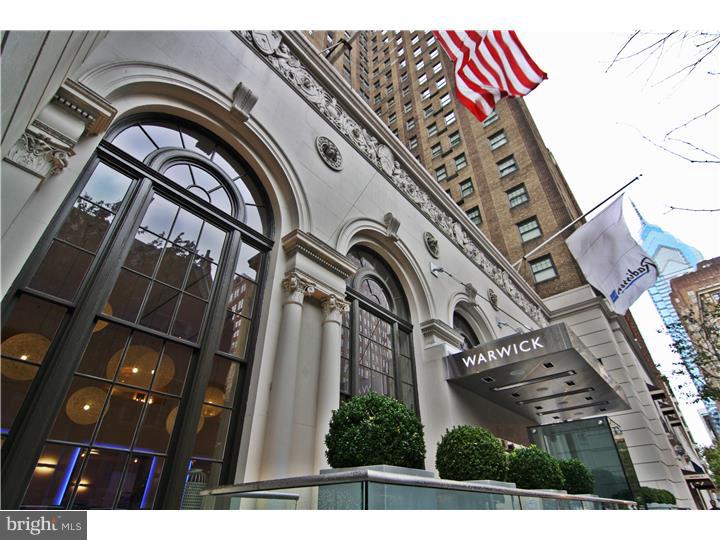 This luxury 2,421 square foot condo sits pinpoint in the city's mainframe, in the historic Warwick building just steps from Rittenhouse Square. Contemporary, refined style distinguishes the unit's 2 bedrooms and 3 baths, which feature a custom work desk, handsome walnut shelving, immaculate finish throughout, and a virtual coliseum of closet space complements of Closet by Design. The master suite opens to granite and marble bathrooms for him and her, replete with heat lamps and a state of the art steam shower. Customized for quality and aesthetics in every detail, this unit remains impeccably itself: its kitchen floods with natural light; its forward-looking appliances, wall-mounted television, and ample cabinetry make for a culinary dream; and its hand-crafted bar stools and breakfast area invite charm and comfort into the space's overall modishness. The hardwood in the living area is stunning, and with plenty of windows offering multiple skyline views from the 14th floor, the place glows. All windows are adorned with specially designed shutters. For friends of the cocktail hour, a bonus wet bar and mini-fridge ornaments the living area as well. Beyond the laundry room inside the apartment, the wall safe, and the alarm system, the Warwick Condominium Residence ensures atypical comfort and security for its tenants, providing trash removal and maintenance, along with all hotel amenities, such as room and maid service, a 24-hour fitness center and concierge, car for hire, and fine dining at the Prime Rib adjacent to the lobby. The Warwick is a pet friendly building.