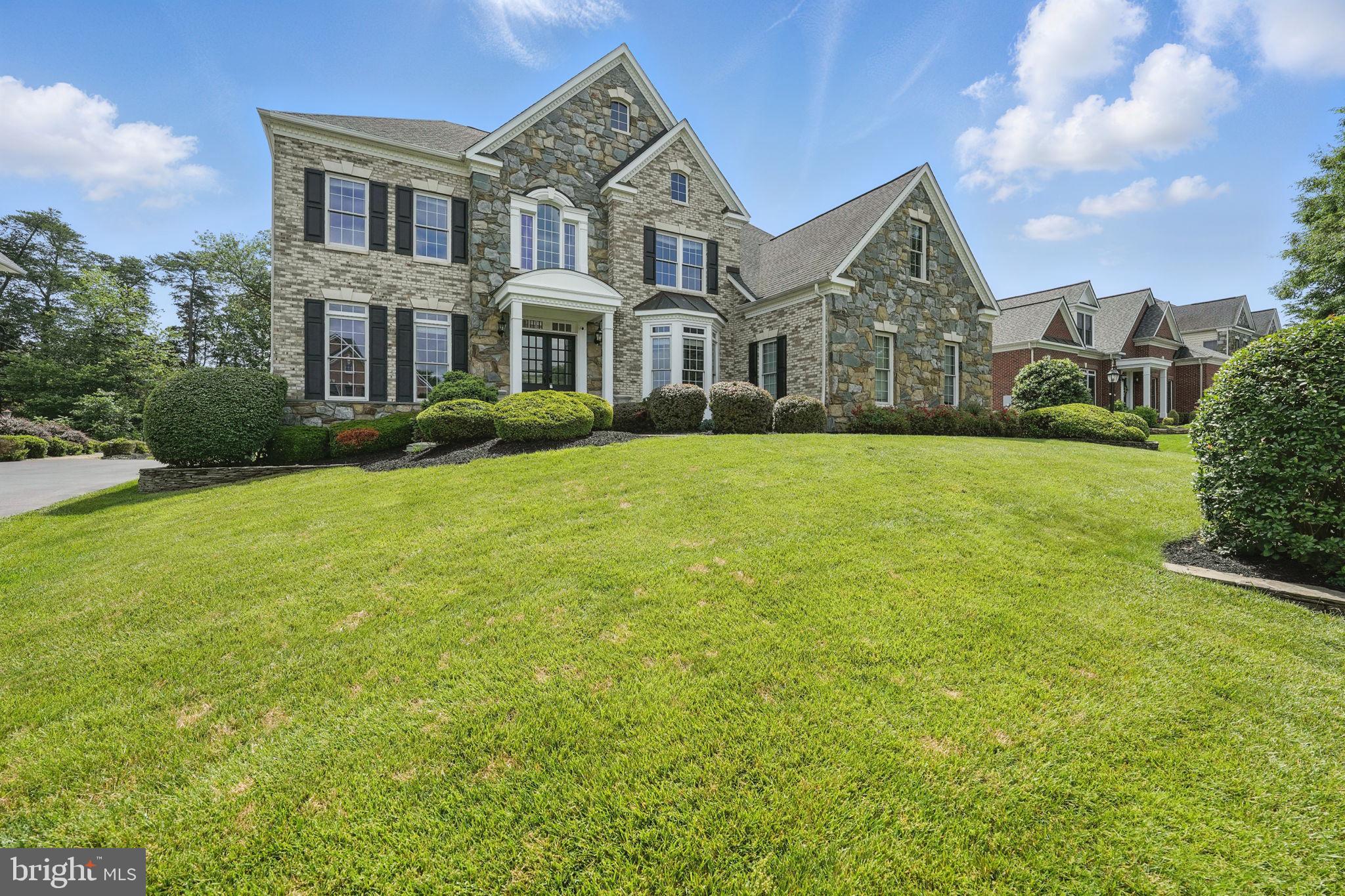 Perched atop a gently sloping & beautifully landscaped knoll, this stunning stone home on just over a 1/2 acre is the pinnacle of luxurious living. The covered front entry with double French doors to the soaring, grand foyer with elegantly curved staircase is breathtaking. Newly refinished hardwood flooring throughout the main level, freshly painted from top to bottom with triple crown molding in every room and shadowboxing & chair rail trim dappled thru-out. All new carpeting on every level brings a crisp & clean edge to this gorgeous home and feels like a new build. No detail left untouched with designer light fixtures, fans & cabinetry hardware, adding custom touches to every room in this 6,741 sq ft home. The sweeping, 2-story great room with floor to ceiling windows, 2-sided fireplace and overlooking catwalk are inviting and cozy, even in their grandeur. Home office with built-ins & double French glass doors beautifully positioned overlooking the rear gardens. Gorgeous & bright sunroom with ceramic tile flooring & windows on every side are the perfect space for morning coffee or afternoons with a good book. The heart of this home is this grand and spacious center island kitchen with newly updated cabinetry & hardware, new Zelige tile backsplash & all new recessed lighting. Granite countertops, stainless appliances & a large corner pantry complement this central and inviting space where you will gather for meals, conversation & laughter. Large corner pantry & butler’s pantry provide ample space for all your cookware, appliances & entertaining needs. Newly tiled mudroom just off the kitchen & garage is the perfect landing space for shoes, coats & bags. Back staircase from the kitchen creates an easy flow to the upper level & primary suite. Octagonal primary bedroom overlooking the rear garden is crowned by a tray ceiling & windows on every wall. Newly renovated dressing area with quartz countertop & designer fixtures. Through double French doors the fully renovated bathroom with standalone soaking tub, elegant & beautiful tilework and stunning double vanities with new light fixtures, mirrors and faucets. Newly renovated walk-in shower is a masterpiece of tile and glass. Dual walk-in closets are oversized and luxurious. Just off of the primary suite is the conveniently located laundry room and a princess suite with updated bathroom and designer Fandelier. Down the hall 2 additional generously sized guest bedrooms share a Jack-n-Jill bathroom - all with new light fixtures and ceiling fans. The Lower level is a veritable destination with its other-worldly home theatre with coffered, wood-beam ceiling, custom wood trim and sconce lighting, theater seating and projector screen. Full wet bar with counter seating, full-sized stainless refrigerator and dishwasher. Rich granite countertops and newly updated tile flooring, all new recessed lights and custom ceiling fans give this space quite an edge! Bar surrounded by recreation spaces, an additional bonus room & fitness center with tray ceiling, industrial flooring and TV wall mount. Full bathroom with terra cotta tile & old world vanity are inviting and elegant for guests. French doors to a walk-up stairway to rear yard create a beautiful flow for backyard entertaining. Stone patio and pergola with tin roof are perfect for rainy evenings and firepits. Trex deck off sunroom and kitchen.
Freshly coated driveway paves the way to your 3-car side load garage with Craftsman Professional series garage system flooring, metal cabinets, storage lockers and workbench. Gentlemen, park your engines! This exclusive and Award-winning golf course community is amenity rich, beautifully manicured and highly sought after. Offering golf course membership & social club membership in addition to the pools, tennis & basketball courts, fitness center, clubhouse, party room, playgrounds and walking trails. Once you move here you will wonder what took so long!