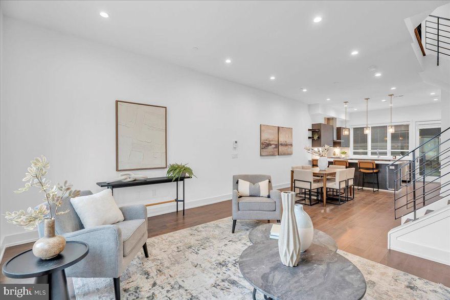 Luxury at Liberty Square! Welcome to 602 N. 5th #5, a new construction home just 4  years young in the heart of vibrant Northern Liberties! This home truly has it all, including 4 bedrooms (+ den), 4.5 bathrooms, 2 CAR GARAGE PARKING, roof deck with skyline views, finished basement with wet bar, top of the line finishes throughout, and approx 6 YEARS LEFT ON FULL TAX ABATEMENT! This interior home within the gated community is the best of both worlds - just steps from everything Northern Liberties has to offer, but  off of the street to give you that extra sense of privacy and security. Notice the beautiful wide plank hardwood floors throughout! As you enter the home you will see the corner 4th bedroom/office with large windows in the front and a coat closet just off the interior garage access in the back. The second floor is an entertainer's delight - wide open floor plan with dramatic ceiling height, plenty of space for a large living room and full dining room, amazing kitchen, powder room and balcony off of kitchen! The kitchen is perfection and includes a Bosch appliance package, quartz countertops, herringbone marble backsplash and lots of counter space and storage! The third floor is as functional as it gets and includes two large bedrooms, both with en-suite baths (one with tub, the other with shower stall), and a large den with a laundry room consisting of full size front load Samsung washer/dryer and custom storage. Juliet balcony off front bedroom with skyline views! The primary suite has the top floor and everything one would need including an enormous custom closet/dressing area, large bedroom with great natural lighting coming in from the large floor to ceiling windows with skyline views and spa-like bathroom with deep soaking tub, his and her vanities, large shower stall with dual rain heads and handhelds and more floor to ceiling windows! Full length roof deck above with amazing views of the city! If you need more recreational space, don't miss the fully finished basement with wet bar and full bathroom! Upgrades include a wireless surround sound system throughout the house including roof deck, custom closets in primary suite, custom storage/cabinets in laundry room and garage, and custom blinds throughout. Within minutes to everything Northern Liberties has to offer. Easy access in and out of the city and over the bridge to NJ. Convenience meets luxury!