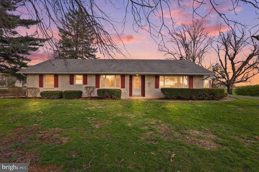 Welcome to 1437 Lititz Rd, a classic 1960s atomic rancher set on .87 acres in a peaceful country setting surrounded by beautiful Lancaster County farmland. If you’ve been dreaming of quiet mornings, wide open views, and the ease of single-floor living, this home offers a rare opportunity to enjoy it all while still being just minutes from Roots Country Market and other local conveniences. With 2 bedrooms, 1.5 baths, and a spacious layout, this home offers excellent potential for expansion, with room to create as many as 4-5 bedrooms and the possibility of adding another full bath to the home. The main level features a large kitchen with abundant cabinet space, charming garden-style display cabinetry, hardwood floors in the living room, main-floor laundry just off the attached oversized 2-car garage, and a bright 4-season room that invites you to slow down and take in the views. Timeless character shines throughout, including two fireplaces, a walk-in cedar closet, a separate tub and shower, and fun mid-century details like a built-in paper towel dispenser and built-in toaster that still work. Downstairs, the huge finished basement opens the door to even more living space, hobby space, or future bedroom expansion. Outside, the massive driveway offers parking for 15+ vehicles, making gatherings, hobbies, or extra storage easy. Adding to the peaceful setting, the land behind the home that was once a golf course is expected to return to farmland, further enhancing the rural backdrop. Here's your chance chance to create the country lifestyle you’ve been looking for in Hempfield School District!