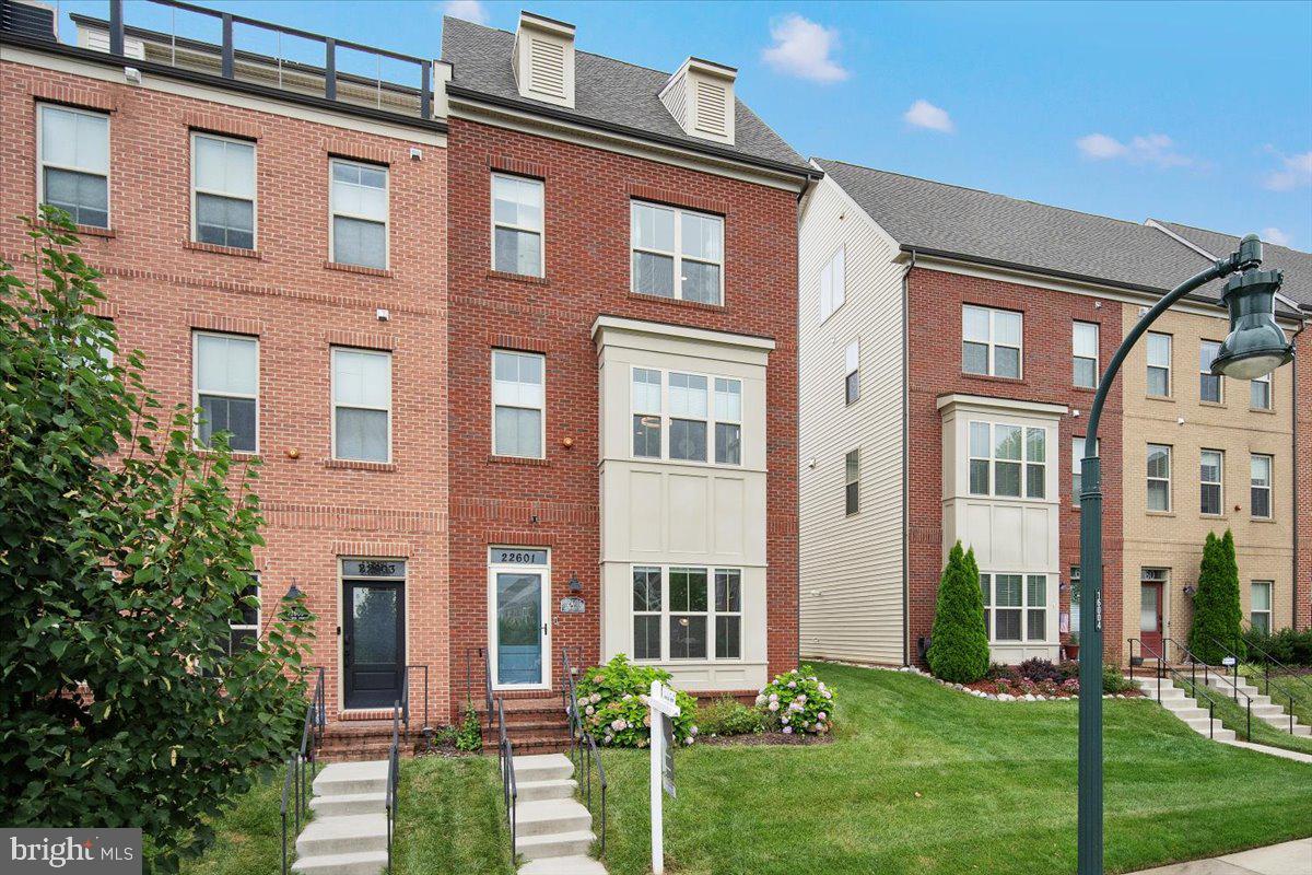 Introducing 22601 Merganser St, this like new four level townhome exhibits elegance, functionality, and modern style all in one. Enter into a well designed foyer with beautiful built in coat shelves. To the right is a large first floor bedroom with its own full bath and large closet. The rear of the first level features a unique extra under stairs storage or wine cave space and a finished spacious two car garage complete with built in storage cabinets and work bench. Up the stairs to the main level is an exquisite open living and dining space. The main living space boasts a designer accent wall, gas fireplace, built in shelving and access to the oversized composite deck (one of only a few in the community!). The large kitchen showcases light gray cabinetry, beautiful stone counters, a built in coffee bar with extra cabinets and stainless steel appliances. A stylish dining space and half bath complete the level. The third level is home to two large bedrooms, one with a large bath that also accesses the hall, and the other with its own en-suite. A walk-in laundry room also sits on this level. The top floor completes it all with a magnificent primary suite and roof top deck! The primary suite features a sliding door out to the roof top deck, walk-in closet, and large en-suite bath with an elegant barn door finish and luxurious enlarged spa style shower. The exterior parking pad has room for two cars and is fully covered by the expanded deck. The home also includes a whole house water softener and filtration system, water pressure booster, and an exterior camera system. Located minutes from the Clarksburg Outlets, restaurants, I-270, Rt 355 and more, this home offers easy access to all commuter routes. It is truly the best that Clarksburg has to offer!