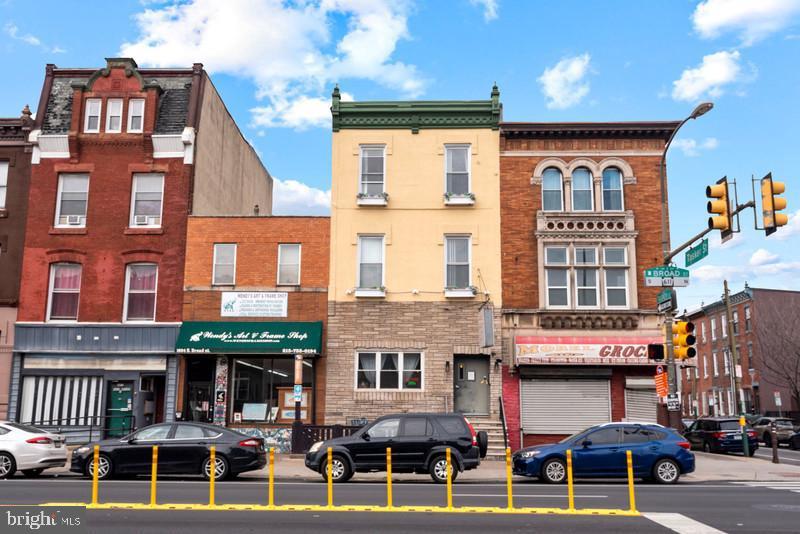 1602 S Broad St is a fully renovated, income-producing triplex located in the heart of South Philadelphia’s bustling Broad Street corridor. The property consists of a leased commercial storefront and two leased residential apartments, offering a turnkey investment with immediate cash flow. Each unit has been meticulously updated with a blend of original architectural character and modern finishes. Interiors feature high ceilings, large windows, in-unit laundry, stainless steel appliances, quartz countertops, and designer tile bathrooms. Smart home upgrades and thoughtful design choices throughout enhance the appeal for both commercial and residential tenants.
The building sits just steps from the Tasker-Morris Broad Street Line station, providing easy access to Center City and other parts of the city via public transit. It’s also located around the corner from the popular Passyunk Square neighborhood, known for its vibrant mix of restaurants, boutiques, and cafes. This high-visibility location benefits from strong foot traffic, dense residential surroundings, and continued growth in the surrounding area. With all units leased and minimal maintenance required, 1602 S Broad St is a strong addition to any investment portfolio.