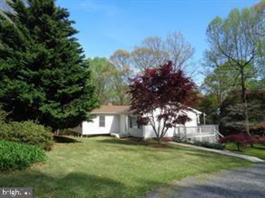 A ton of house for the price! This house is very private on an acre lot with no HOA and a 2 car detached garage with power and plumbing.  The house has a newer HVAC with a 10 year transferable warranty, and a HUGE primary bedroom! So much potential here. This house as it sits is 100% in a condition to buy, move, and live and make updates as you can and create instant equity. Offering over 3900 finished living space, 3/4 of a finished basement with a full bathroom, walk-out basement and a great area to add a 4th bedroom with a proper egress. The owner is selling this house as-is meaning no repairs but it is in good working order. The chimney is unknown as to if it is in operating condition and being sold as-is. The oversized garage is a huge bonus to this property with electric and plumbing for a half bathroom it can not get better than that!! Owner removed the garage doors due to condition and the price reflects the needed or wanted updates.  Get a 203k rehab loan to make the updates you desire or just finance it and live!  With the upgrades you want to make this house could easily be worth 500k!  Come and see this on before it is gone!  Community beach & boat ramp access to Calvert Beach best of all worlds...private, detached garage, no HOA, and beach access!