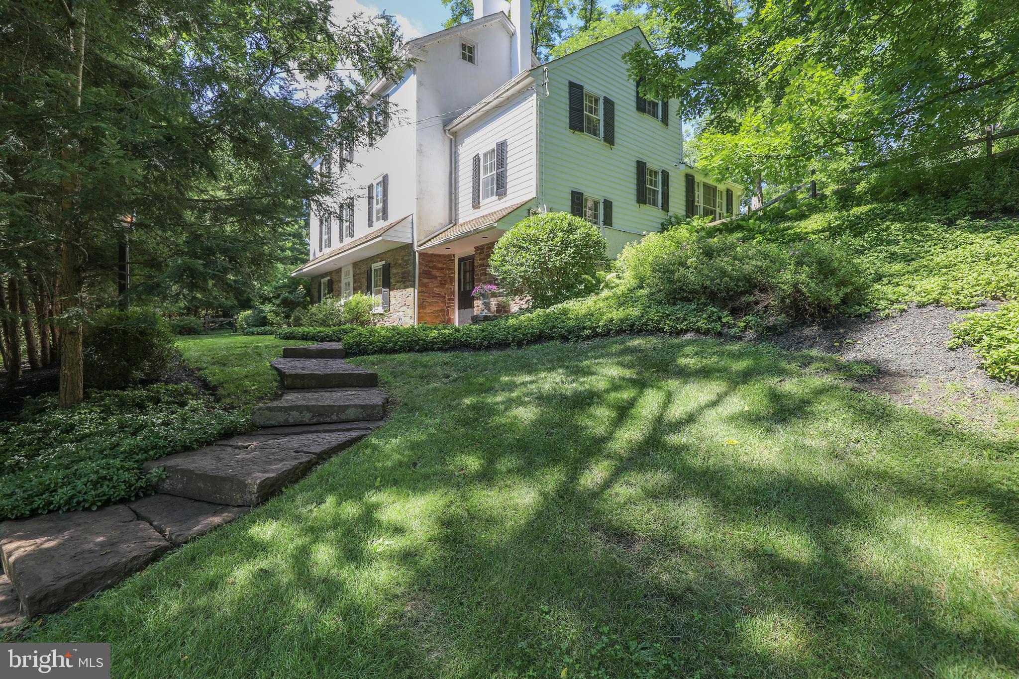 The owners are ready to part with this extraordinary residence. Walnut Hill Farm, an impressive stone and plaster 1800's home and barn rests proudly on a wooded hillside in Bucks County just minutes from the Delaware River. Framed in a remarkable setting of almost 5 acres, there are bucolic vistas from every window. Park-like lawns gradually roll into the surrounding woods. Renovated to suit modern, sophisticated tastes by a NYC designer, this genteel estate offers the tranquil, soothing rewards of country life with luxury, modern amenities. A property with this lovely combination of sophistication and charm is rarely available and Walnut Hill Farm is ready to move in. Both inside and out, the 1800 s character and timeless dignity are evident. Random width flooring, open beamed ceilings, deep windows and period detailing skillfully blend with custom cabinetry, marble, tile and mahogany appointments. The gourmet kitchen boasts Viking appliances and opens to a sun room, bathed in light. Step outdoors on to the large terrace to bask in the park like setting. A stunning stone wall lines a portion of the property's perimeter, and lends a sense of substance, privacy, and tranquility to the backyard. The typical farmhouse rooms have been opened up to create comfortable living space that works equally well for entertaining. With fireplace walls at either end of the living room, random width plank floors and beamed ceiling, the original interior offers the soothing rewards of country life with modern conveniences. An original pie stairwell leads from the first floor to the attic and includes built-in wine racks lining the walls. The master bedroom includes six deep set windows, fireplace and luxurious master bath with custom tile, double shower and wet steam sauna. A guest suite of 3 rooms on the first floor includes a private entrance, walk-in fireplace, beamed ceilings and newly designed bathroom. A Currier and Ives country barn offers garage and plenty of storage and workspace for hobbies, storage and studio. An acre lined with dog fencing allows pets to romp without worry. The perfect country getaway, Walnut Hill Farm is convenient to restaurants lining the Delaware River and gourmet food stores. Sophisticated and charming, you will not be disappointed by this rare Bucks County gem.