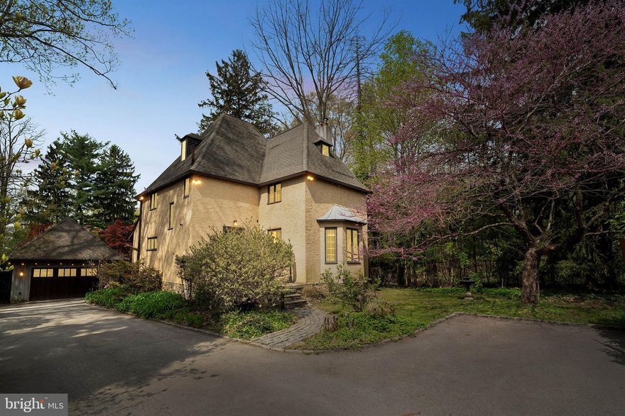 Tucked away on a secluded lot with lush landscaping and a long private driveway, this one-of-a-kind home blends old-world charm with thoughtful modern upgrades—and an enchanting courtyard retreat that feels like a private oasis.

Step into a welcoming tiled foyer and immediately feel the warmth of this unique architectural gem. The sun-drenched living room offers classic elegance with refinished hardwood floors, a wood-burning fireplace with a wood stove insert, built-in shelving, custom blinds, and a cozy reading nook. The open flow leads into a spacious dining room featuring built-in shelving, a beautiful chandelier, and sliding doors with decorative wrought iron accents overlooking the breathtaking brick courtyard.

The kitchen is a cook’s dream—reimagined with style and function in mind. Enjoy heated tile floors, recessed lighting, maple cabinetry, granite countertops, a gas oven, dishwasher, and a striking live-edge breakfast bar. A stunning custom portico was recently added to the back entrance, offering charm and curb appeal.

Upstairs, the second floor features a generous primary bedroom and ample closet space, two additional bedrooms, and an updated tiled bathroom with a stall shower (with seat), a new glass enclosure, vanity, and custom blinds. The third floor boasts a versatile fourth bedroom with high ceilings, a large closet, and a full bath with a classic clawfoot tub—perfect for guests or a serene home office.

The full walk-out basement with laundry area offers potential for additional living space, while the oversized two-car garage includes a fully floored second level for storage or a creative workshop.

But the real showstopper? The private, walled brick courtyard with wrought iron gates, blooming perennials, and peaceful seating areas. It's truly a hidden sanctuary. The large backyard also includes green space and a mature, fruit-bearing pawpaw tree.

Located directly across from the scenic Haverford College walking trail and minutes from Ardmore’s shops, restaurants, and regional rail lines—including the Paoli/Thorndale and Norristown High Speed Line—this home offers exceptional convenience with serene, storybook living.

This is not just a house—it's a rare opportunity to own a home that inspires. Schedule your showing today!