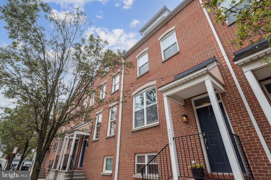 Welcome to 2334 Cambridge Walk. A 2-car garage townhome with 4 levels of living space, is located on the border of Canton and Fells Point. Walk to the heart of either within minutes. 3 blocks north to Patterson Park or 1 block south to the waterfront promenade. The main level features an open concept kitchen, living, and dining room with 9-foot ceilings and hardwood floors. Although plenty of cabinet space, you also have a walk-in pantry.  A conveniently located ½ bath on this same level. One level up features 2 well-appointed bedrooms each with their own full bath. Primary suite features a large walk-in closet. In addition, this floor also has a laundry with new washer and dryer. Both oak and hickory floors throughout this level. The top level is a multifunctional room that could be used as a 4th bedroom, den, office, media room. Located just off this room is a 21x20 deck with incredible views of Downtown and Inner Harbor East. The lower level includes a bedroom and full bath just adjacent to the 2-car garage. Most windows replaced in 2021, new HVAC system in 2019. The perfect home and location for city living.
