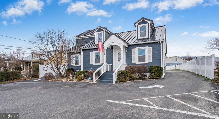 Rare opportunity!  Perfectly positioned in the heart of historic Harpers Ferry, this fully renovated Cape Cod offers exceptional flexibility with zoning that supports residential, commercial, or mixed-use living. Thoughtfully redesigned and updated in 2025, the property seamlessly blends character, modern function, and income potential — making it ideal for investors, owner-occupants, or entrepreneurs seeking a true live-work solution.
Offering nearly 1,850 square feet of finished space, the home is intelligently configured to function much like a spacious duplex with two private entrances, allowing for complete separation and privacy.  Whether you envision a high-performing short-term rental, multigenerational living, or a home-based business, this layout adapts effortlessly to your goals.
The main level features two fully updated kitchens, two laundry areas, three full baths, formal living and dining spaces, and a versatile flex room.   A highlight of the home is the turnkey Airbnb-style suite, complete with a Murphy bed, full kitchen, walk-in shower, dedicated laundry and dressing area — perfect for guests, extended family, or rental income.   An oversized primary bedroom with a beautifully updated ensuite bath further enhances the home’s residential appeal.
Upstairs, you’ll find three additional rooms, a half bath, and a loft-style space ideal for a media room or game area.  Two of the rooms include their own shower stalls and sinks, offering added privacy and convenience for guests or multiple occupants.
This property comfortably accommodates large groups (up to 10 guests) and is well-suited for:
• Living in one side while generating rental income from the other
• Multi-family or intergenerational living
• Housing traveling professionals, contractors, or medical staff
• Operating a business, salon, or studio on one side while residing in the other (previously a long-running, successful spa and salon)
Property Highlights:
• 1,848 sq ft of finished living space
• Five bedrooms plus a private income-producing suite
• Three and a half bathrooms
• Two full kitchens & two laundry areas
• Two living rooms & two dining rooms
• Metal roof (2023) & new water heater (2025)
• Nine off-street parking spaces plus street parking
• Two-car garage & outdoor living area
• Handicap-accessible ramp
• All Airbnb furnishings and business contents convey
• Walkable to downtown Harpers Ferry, shops, dining, and trails
This is a truly versatile asset in one of West Virginia’s most sought-after historic destinations — offering lifestyle flexibility, strong cash flow potential, and unbeatable walkability.  A rare chance to own a property that works as hard as you do.