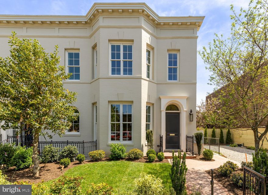 333 12th St NE is an exceptional and sophisticated semi-detached Capitol Hill rowhome that has been completely reimagined with the highest quality craftsmanship and precision. Behind the carefully restored historic brick façade is a new structure that has been built to impress and finished with timeless details. This grand 5 bedroom home with 3 full baths and 2 half baths features soaring 11’ ceilings, enormous new windows and doors, two kitchens, two living rooms, a stately primary suite, a private second-floor terrace, an 800-square-foot roof deck with panoramic views of the city, off-street parking and a large yard with mature trees and plantings.

The trim details, marble tile, and antique brass hardware throughout are a rare find in new construction and reminiscent of the finest historic homes in Capitol Hill. Top-of-the-line Thermador appliances, Kohler plumbing fixtures, and three HVAC systems provide all the comfort and performance of a true luxury custom home.

Upon arrival, you will enter into a stunning foyer with marble-tiled floors, decorative lighting, and unexpected closet storage hidden behind custom millwork. As you turn the corner, you will be mesmerized by the ceiling height, trim details, and a feeling of elegance. The kitchen features floor-to-ceiling cabinetry, panelized appliances, soapstone countertops, marble backsplash, a custom chimney-style hood, and a rounded tray ceiling with a decorative light fixture to complement the undercabinet and recessed lighting.

The spacious dining area incorporates the classic bay window, giving it a bright and airy feel. The grand living room features a stunning fireplace with a custom mantle and marble hearth, traditional coffered ceilings, and abundant recessed lighting. The first floor is completed by a beautiful half bath and a tucked-away laundry and pantry room with ample storage. Upstairs, the magnificent primary suite with room for a King bed and multiple furniture pieces includes a walk-in closet with custom built-ins and a luxurious bath with a decorative double vanity, a large walk-in shower, and a freestanding tub.

The second floor is completed by two additional bedrooms and another full bath, as well as a private roof terrace. At the top of the stairs, you will find a serving bar in the penthouse perfect for entertaining on the expansive roof deck complete with a custom trellis, a gas connection for a grill or fire pit, and pre-wiring for an outdoor TV.

Downstairs, the fully equipped lower level of the home can be used to fit any lifestyle with its private entry, full kitchen, living room, two bedrooms, full bath, and half bath. Capitol Hill is more than a neighborhood – it’s a lifestyle. Around the corner from top- rated Maury Elementary and a short walk to Lincoln Park and Eastern Market, this home offers a rare opportunity to purchase a timeless property that will serve your family for generations. Monarch Urban is a seven-time national-award-winning developer and this is their best work yet. Schedule your showing today to experience this incredible residence.