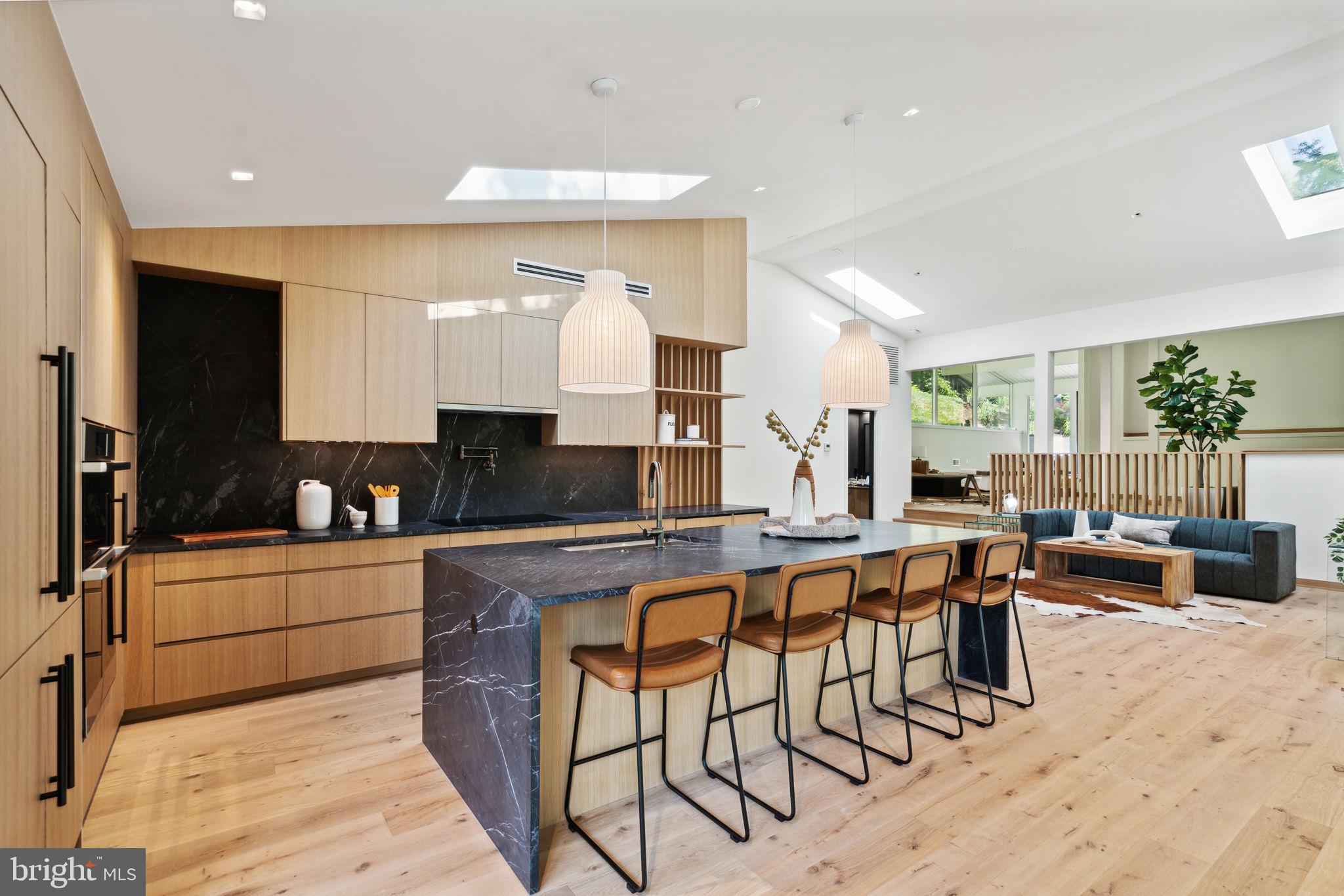 Step into the timeless elegance of this Mid-Century Modern masterpiece nestled on 4 acres of picturesque landscape in Villanova. This architectural gem seamlessly combines the best of retro design with modern amenities with the full rehab of the existing home and new addition by the builder, creating a home that exudes sophistication and style. There is nothing like this available anywhere on the Main Line! Pickleball/Sport court, 4+ car garage, additional "guest house/artist's suite" detached from the main home and a custom designed floor plan with the best finishes and expert craftsmanship. The main residence boasts the iconic clean lines and open spaces characteristic of Mid-Century Modern design. Floor-to-ceiling windows flood the interiors with natural light, framing breathtaking views of the surrounding greenery. A spacious living area with a fireplace becomes the heart of the home, offering a cozy retreat for relaxation. There is a large addition to this home that is completely new construction. With six bedrooms and four and a half bathrooms, this home offers ample space for both relaxation and entertainment. The large primary suite is a haven of tranquility, featuring a spa-like full bathroom with a soaking tub, sunlight drenched shower and beautiful fixtures, the perfect retreat after a long day. Step into culinary excellence with this luxurious chef's kitchen, where form meets function in a symphony of sophistication. Every detail has been carefully designed to elevate your cooking experience to new heights. The kitchen is adorned with high-end finishes, from the gleaming countertops to the custom cabinetry that offers both style and ample storage space. The expansive island, with double waterfall counters, is a centerpiece of culinary artistry, and provides a generous workspace for food preparation and casual dining. Situated on a sprawling (+/-) 4-acre lot, this property is a true oasis of privacy. complete with a tranquil waterfall, and a charming stone bridge that adds a touch of romance to the property. Enjoy the tennis court, and host your very own pickleball tournament or retreat to the expansive detached garage with space for 4+ cars to work on your favorite hobbies. The possibilities are endless with the versatile guest house on the lot, ready to be transformed into a guest suite, office, gym, art studio, or whatever suits your lifestyle. Embrace the serenity of this private and secluded estate, where every detail has been carefully curated for a life of comfort and indulgence. With endless possibilities at your fingertips, this Villanova residence is more than just a home; it's a canvas for your unique vision of luxury living. Taxes and square footage are the responsibility of the buyer to have verified. All square footage is above grade and does not include the "guest house".