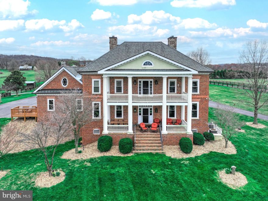 Welcome to your stunning custom Georgian style colonial home, nestled on nearly 15 acres of picturesque landscape with breathtaking views of the Blue Ridge Mountains. Inspired by the elegance of the governor's mansion, every aspect of this home has been meticulously crafted, leaving no detail untouched. 
 
From the moment you arrive, you'll be captivated by the charm of this residence. Adorned with four sides of Flemish bond brick, the exterior exudes timeless sophistication. Step onto the two-level main and upper-level covered verandas, offering sweeping vistas that stretch for miles. 

Inside, the Heart of Pine floors, reclaimed from an 1800’s barn in Massachusetts, infuse warmth and character throughout. Walnut doors, embellished with Baldwin Brass locks, and custom moldings add to the home's refined ambiance. 

Indulge in the comfort of four exquisitely appointed gas fireplaces, each adorned with period-style mantles, creating a cozy atmosphere in the main rooms of the main level. Original period-style lighting further enhances the home's charm. 

The gourmet kitchen features granite countertops, walnut cabinetry, and top-of-the-line appliances, including a SubZero refrigerator, Thermador gas range, and Asko dishwasher. A large walk-in pantry and butler's pantry ensure effortless entertaining. 

The fully finished walk-out basement, completed in 2021, offers additional living space, including a generous-sized family room, full bathroom, and two versatile rooms ideal for office space, a crafting room, or a home gym. 

For equestrian enthusiasts, this property is a dream come true. The land is meticulously set up for rotational horse grazing, with access to trails.  A three-stall barn, complete with a heated tack room, wash stalls, and vet station, provides all the amenities needed for horse care. Above the barn, a beautifully renovated space awaits, perfect for hosting meetings or converting into a living space or in-law apartment. 

Discover hidden gems throughout the property, such as the secret door concealing an additional room in the barn-style apartment. Spend leisurely afternoons fishing in the fully stocked pond or gliding across its surface in a paddle boat. As the day draws to a close, unwind on the veranda with your favorite beverage, soaking in the magnificent sunset. 

Welcome home to a lifestyle of luxury, tranquility, and unparalleled beauty.  *RECENT APPRAISAL OVER LIST PRICE*