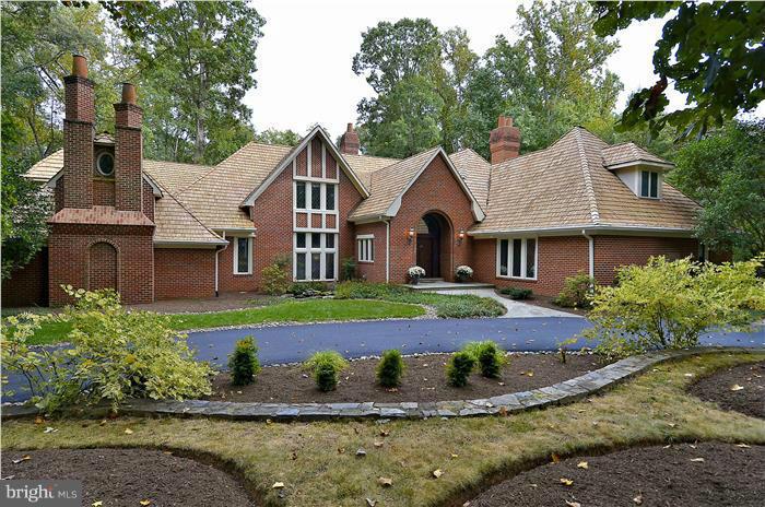 Come discover this beautiful and unique English Manor home. Explore the exquisite professionally landscaped garden with waterfalls, koi pond, a tennis court and a winding stream leading to a black bottomed pool and spa. The Tudor styled home has a gourmet French Country kitchen, gleaming hard wood floors, first floor master suite and another full kitchen in the basement. This is a real gem! Updated photos coming soon.
