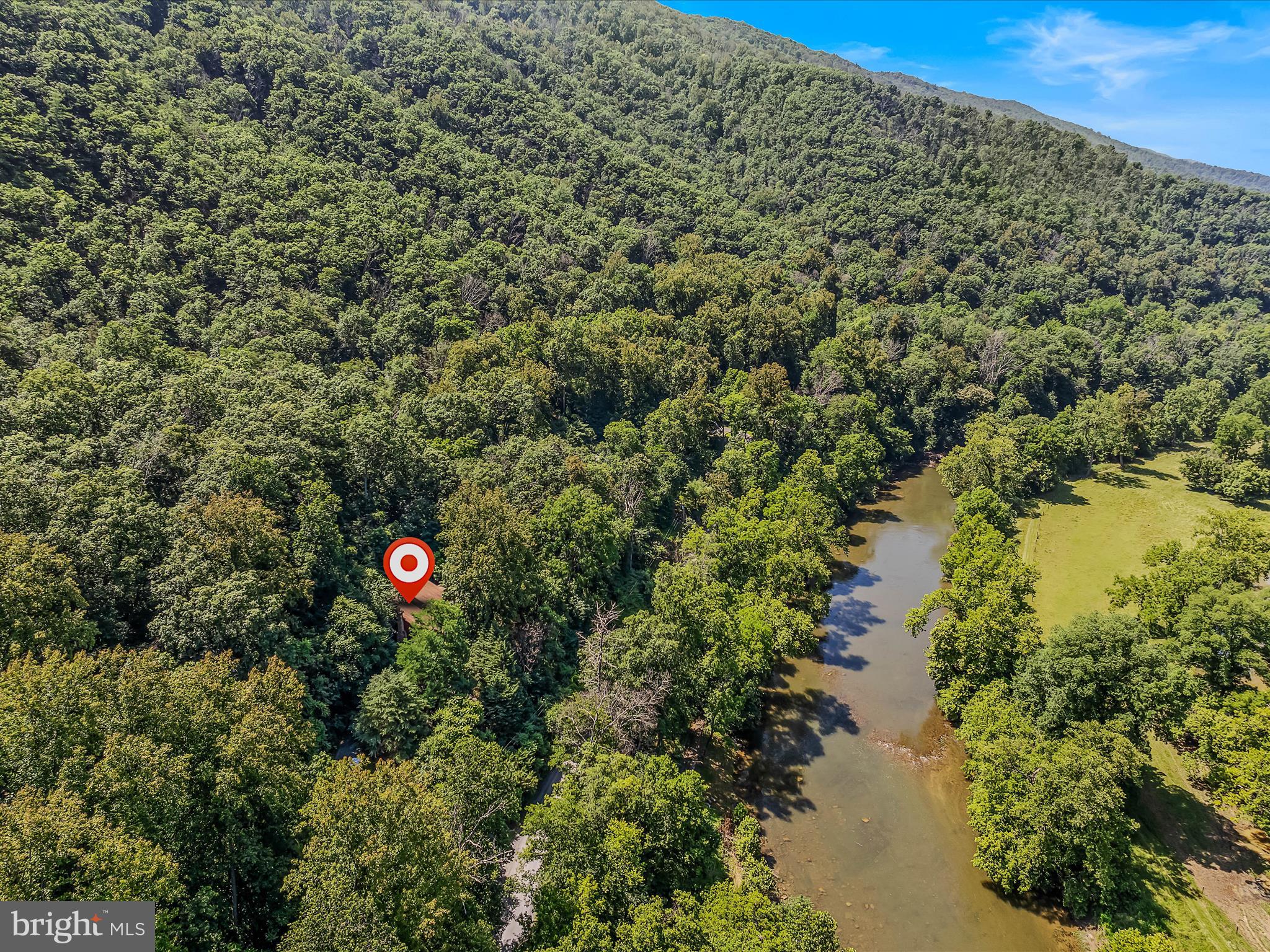 Escape to your personal oasis along the serene North Fork of the Shenandoah River! Nestled on 3.44 acres with approximatley 360 ft of river frontage, this charming home offers an idyllic retreat with private river access perfect for fishing, kayaking, canoeing, and enjoying nature! The spacious living room flows seamlessly into the kitchen, which boasts stainless steel appliances and plenty of room for cooking and entertaining. Step into a warm and airy living room featuring soaring exposed woooden beams and a striking stone wood-burning fireplace, creating a cozy yet grand atmosphere for gatherings or quiet evenings by the fire. Equipped with a whole-house generator, this ensures uninterupted comfort and security during any weather! You can enjoy this beautiful home year round, as a weekend getaway from the hustle and bustle of the busy life, or start your own Airbnb. Take day trips to the many wineries and craft beer spots, enjoy the local flavor of the country, and extraordinary views. Upgrades include: Septic pumped in (2025), A/C (2024), Furnace (2015), Roof (2016), Well Pump (2025), Instant Water Heater (2013), Whole House Generator (Serviced Yearly). Local restaurants in Strasburg, Woodstock and Edinburg! Public river access and the scenic swinging bridge is approximately 1.4 miles away! Don’t miss this incredible opportunity to own a riverfront home that combines modern amenities, privacy, and outdoor adventure!