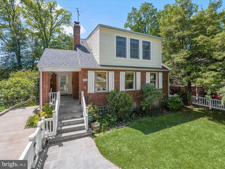 Welcome to this beautifully updated three-level home that blends modern comfort with timeless character, located just over a mile from the heart of Downtown Silver Spring. A charming white picket fence and manicured front yard set the stage, with a slate stone walkway guiding you to the covered front porch, a perfect spot for morning coffee or evening conversation. From here, step directly into the living room or kitchen, each entrance offering its own warm welcome. Inside, the expansive living room showcases gleaming hardwood floors and a brick-accented wood-burning fireplace, creating a cozy yet spacious atmosphere for gathering. Flowing seamlessly from the living area is the open-concept kitchen and dining room, where a vaulted ceiling and two skylights flood the space with natural light. The kitchen has been thoughtfully renovated with sparkling counters, stainless steel appliances, and cabinetry outfitted with multiple roll-out storage options. A center island with breakfast bar invites casual meals and conversation, while the adjoining dining area opens to a spacious deck through sliding glass doors, perfect for outdoor entertaining. The main level also offers a versatile bedroom and full bath, ideal for guests, a home office, or multigenerational living. Upstairs, two skylights brighten the hallway, leading to two generously sized bedrooms, each with a vaulted ceiling and en-suite bath. The primary suite impresses with three closets, plentiful windows, and a luxurious bath featuring a jetted soaking tub and beautifully tiled shower surround. Downstairs, the fully finished lower level provides even more living space, including a recreation room with luxury vinyl plank flooring, a wet bar with beverage refrigerator, a stylish half bath, and a fourth bedroom. A barn door reveals the laundry room, complete with utility sink and storage, and there’s a dedicated room for a workshop or additional storage needs. Step outside from the lower level to a private backyard framed by mature trees, with a storage shed and space to relax or play. Thoughtful updates add lasting value: the roof is just three years old, and both the driveway and retaining wall were recently redone. The home is outfitted with quality Andersen windows that enhance both form and function. Additional upgrades include a tankless water heater replaced in 2021 and a dual-zoned HVAC system replaced in 2024. Parking is easy with both a driveway and street options available. Life on Gist Avenue offers easy access to the dynamic energy of Downtown Silver Spring. From shops and restaurants to cultural landmarks like the AFI Silver Theatre and The Fillmore, there’s always something to explore. Seasonal events at Veterans Plaza, the nearby Metro station, and an abundance of parks and trails round out this ideal location, placing everything you need right at your doorstep.