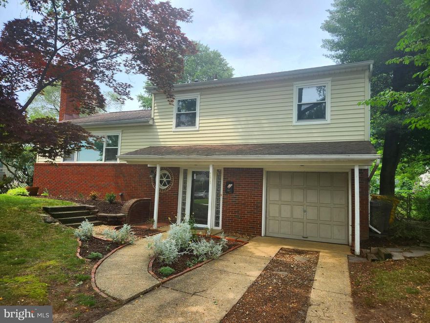 Four Level Split freshly painted  with wood floors & fireplace situated on wooded lot & plenty of room to spread out with bedroom or den on first level & half bath, walk up a few steps to kitchen & spacious living area with fireplace & dining area.  Step out of the kitchen to a nice size back yard!  Only a few steps up with 3 bedrooms & full bath,!  Lower level includes extra recreation space with large laundry & storage.  One car garage & easy commute to Ft Meade, shopping area & access to Rt 3 & 100!