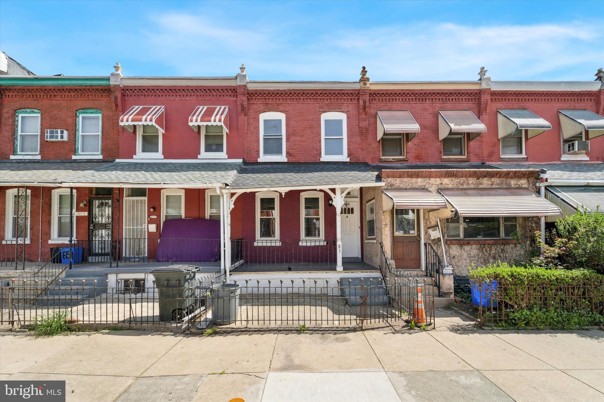 Looking for a home with real character—one that’s move-in ready, thoughtfully updated, and still full of historic charm? This classic Philly rowhome delivers all that and more, at a price that makes homeownership finally feel within reach. A welcoming, fenced-in front yard and covered porch set the tone, leading you into a traditional entryway that opens to a sunlit living room. An original fireplace mantle adds timeless detail, grounding the space with warmth and authenticity. Just beyond, the dining area offers plenty of room for gatherings and everyday life. Toward the rear, the renovated kitchen shines with white shaker cabinetry, stainless steel appliances, and a gas range. A painted brick mudroom, complete with laundry hook-up, opens to a large, fully fenced backyard—offering rare outdoor space on this nearly 100-foot-deep lot. Downstairs, a freshly cleaned, unfinished basement provides excellent storage or future possibilities. Upstairs, you’ll find a bright rear bedroom overlooking the yard, a stylish hall bath with a walk-in shower, and a middle bedroom that connects to the primary—perfect for a nursery or work-from-home setup. The primary bedroom sits at the front of the house, with two large windows that flood the space with natural light. Original railings and trim add personality throughout. With street parking on both sides and Lancaster Ave just a quick walk away for public transit, convenience is part of the package. If you're finally ready to make the leap into homeownership, this gem is waiting for you.