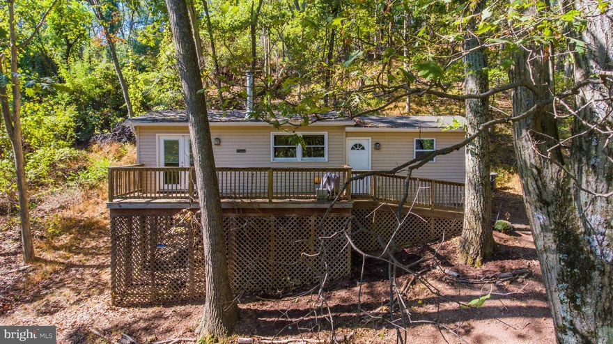 Cozy up in this privately located 2 bedroom tiny home with community lake access and recreational fields.  Central HVAC and a recently installed woodstove will providing heat through the winter, and the beach is there for cool days in the summer.  The fully furnished galley kitchen features a flexible dining space leading into an open living room.  It's all here in affordable fashion.