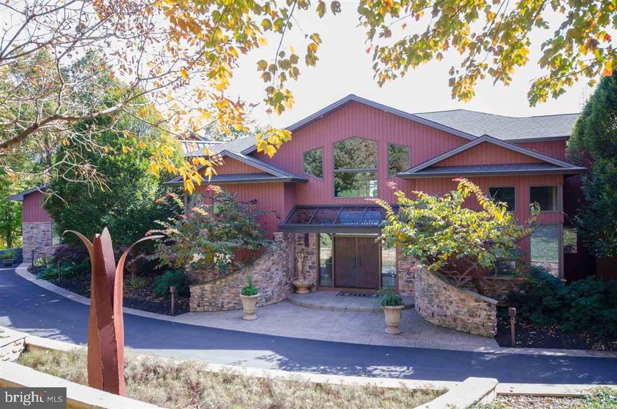 This show piece home has panoramic views & quality features that will amaze!  Maple Kitchen w/granite, breakfast bar, butler pantry, step into a warm Family room on one side and into a spacious Living/Entertainment area w/double sided stone FP, sunk wet bar & dual staircase leading to MBR suite.  Bedrooms have bath & door to deck. Finished walkout LL, 4 car attach garage, plus 4 car detach. Inground pool & hottub.