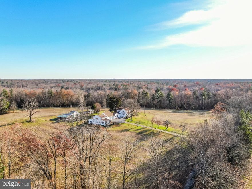 MOTIVATED SELLERS! BRING ALL REASONABLE OFFERS! Welcome home to this private estate situated on 36 sprawling acres in Bowling Green. With over 4,000 finished sqft, this property is filled with detail, history, and endless amounts of character. The main house, originally built in the late 1890's, restored in 1986, continues to boast old charm but is fully equipped with modern conveniences. It features 3 beds, 2 baths, original hardwood floors throughout, kitchen with updated granite countertops, a library, a 12x12 walk in closet and ample amount of living space. The detached studio built in 2014 recently received a new roof in 2020, and has plenty of flex rooms along with a full bathroom. It is perfect for guests, large gatherings, or could easily transition to be a mother-in-law suite. The outdoors are just as exceptional with a beaver dam, shooting range, Japanese Maples, apple trees, 25' grape trellis, and a fish pond with a pergola and stone accents. This is a rich and bountiful property with an abundance of wildlife and sites for birdwatching.  The large shed/workshop has plenty of space for equipment along with a work and covered area for all kinds of projects and storage. Endless possibilities!