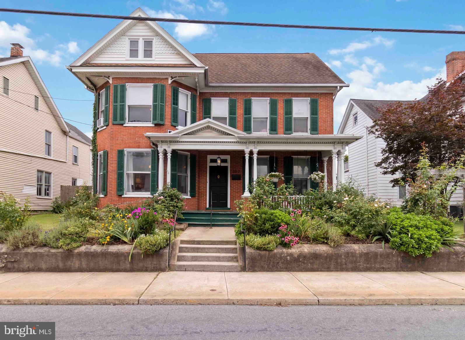 Welcome to 302 E Orange Street, a spacious 5-bedroom, 3-bath home in the heart of Shippensburg’s Historic District, offering charm, versatility, and layout flexibility. From the inviting front porch to a lush backyard and private balcony, every corner delivers character and comfort. The first floor features a bright living room, formal dining area, updated kitchen, and convenient first-floor laundry. Upstairs, you'll find four bedrooms, a bonus room, and a full bath with walkout access to the balcony. Not pictured is new laminate flooring in the second floor bathroom. The third floor reveals a private suite with bedroom, full bath, and kitchenette—ideal for guests, multi-generational living, or rental potential. A detached 2-car garage, paved alley access, and additional off-street parking add convenience. Key highlights include a third-floor suite, oversized garage, garden views, and walkability to local shops and dining. Located within Shippensburg’s Historic District, this property blends timeless appeal with vibrant community surroundings. Seller is offering $10,000 in assist to support updates or closing costs. Pre-listing home and pest inspection reports are included for buyer confidence. Whether you’re seeking a primary residence, investment opportunity, or flexible living arrangement, this home delivers exceptional value and unique character!