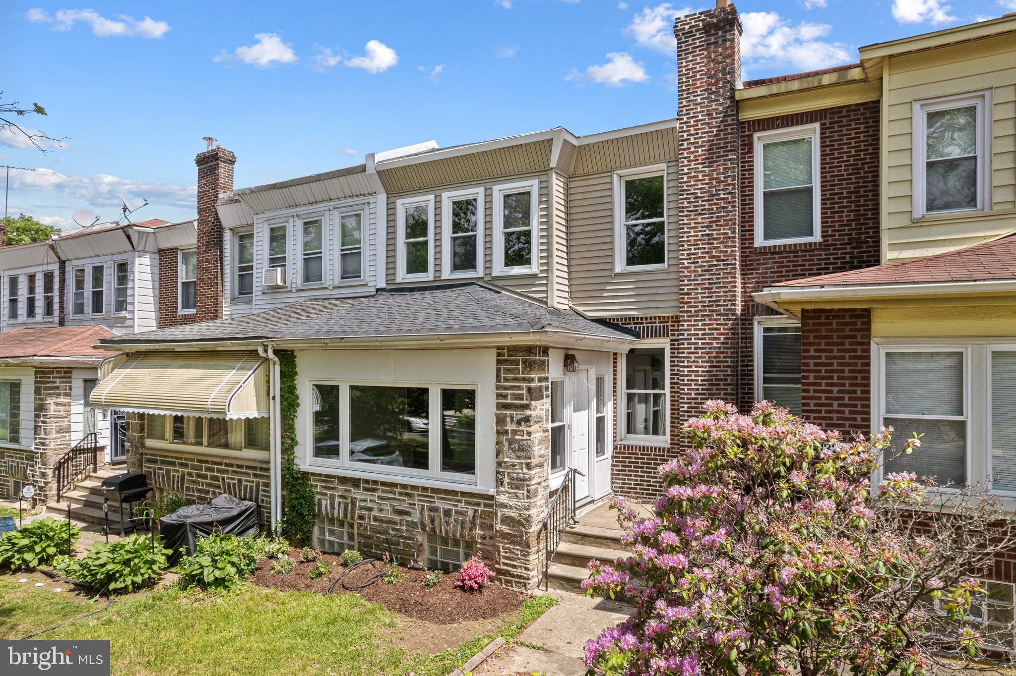 This beautifully restored classic in the East Mount Airy section of the city blends timeless charm with modern comfort. This highly desired tree lined block of Phil Ellena is ready for you to call home. Stroll past the landscaped front lawn into a welcoming enclosed sun porch — the perfect spot to unwind. French doors fill the living room with natural light, complementing the warm hardwood floors that continue throughout the home.
The well-appointed kitchen features stainless steel appliances, a double-door refrigerator, and an open breakfast bar that flows seamlessly into the dining area — ideal for easy entertaining. From here, double doors lead to a spacious rear deck, offering room to grill, garden, or simply enjoy the warmer months outdoors.
Upstairs, you'll find three generously sized bedrooms with original wood inlay flooring, along with a bright, tiled hall bathroom. The finished lower level adds valuable living space, a second full bathroom, laundry area, and a walk out basement which leads to the garage.