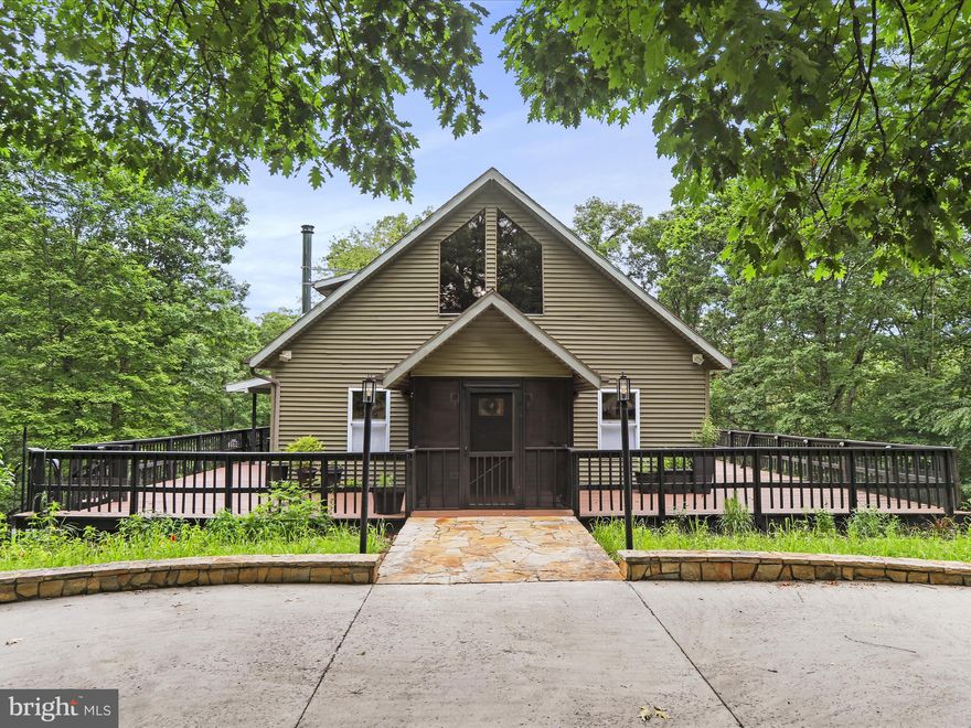 Welcome to your mountain escape! Nestled in the heart of Hedgesville’s scenic landscape, this custom home combines modern comforts with rustic charm. Surrounded by countryside for peace and privacy. A large wrap around porch lets you enjoy year round panoramic views of mature woodlands and abundant wildlife. The fenced in yard offers vegetable gardens, mature fruit trees and a fire pit ideal for stargazing, storytelling, and making s’mores. Inside you will find an updated, energy efficient HVAC system, a fully remodeled bathroom and kitchen complete with modern appliances, custom window treatments, LARGE pantry, and updated flooring throughout. The soaring wood ceilings and abundance of natural light makes for a home that’s perfect for relaxing or entertaining. Don’t miss this rare opportunity to own a slice of paradise! Schedule your private tour today and discover why 44 Wild Rose Court is more than just a home — it’s a lifestyle.