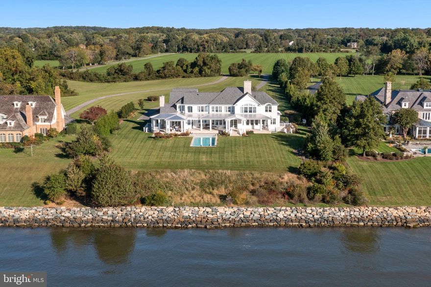 This extraordinary south-facing estate offers 210 feet of waterfront with sweeping, unobstructed Chesapeake Bay views, providing magnificent sunrises and sunsets. It is situated on 3.10 acres in the exclusive Maidstone Farm community. This custom-built residence combines architectural sophistication, high-end craftsmanship, and state-of-the-art amenities to create a truly luxurious waterfront retreat. Designed by ABS Architects in 2019, the home includes a saltwater pool and features five ensuite bedrooms and 6.5 baths with custom tile work and high-end fixtures. The open floor plan and flexible living spaces allow seamless flow between living, dining, and entertaining areas, with multiple rooms offering panoramic water views, four fireplaces (two propane), and numerous built-ins. Upon entering, you are greeted by a dramatic staircase, coffered ceilings, crown moldings on the first and second floors, 8-inch baseboards, 4-inch recessed lighting, 10-foot ceilings on the main level, 9-foot ceilings on the second floor and basement, and 8-foot solid wood doors throughout, with framed access for a future elevator. The gourmet kitchen includes two large cooking islands, a La Cornue range and oven, two Sub-Zero refrigerators, two Sub-Zero refrigerator drawers, and an additional small Sub-Zero refrigerator, with mitered-edge countertops and premium hardware. All five bedrooms are ensuite, and each bath features custom tile work, designer fixtures, and integrated lighting. The primary suite includes a barreled ceiling, sitting room, spacious walk-in closet, and panoramic water views. A large flex space above the garage with a full bath and exercise room provides additional options for a guest suite, office, or studio, and the unfinished basement spans 3,664 square feet, offering significant potential for recreational or storage space. This property offers privacy, exclusivity, and easy access to the Chesapeake Bay, while being located in Maidstone Farm, known for its tranquil setting  and proximity to Annapolis City Dock, fine dining, shopping, and cultural attractions. Additional amenities include a covered water-side porch and veranda, a flat yard ideal for entertaining, wedding tents, or sports, an extra-deep 4-car garage with ample driveway parking and circular driveway, and a dedicated 30-foot pier with lift in the community marina. The home is equipped with a six-zone HVAC system with gas backup and humidifiers, spray foam insulation, a 400-amp electrical service, a Kohler propane-powered whole-house generator with 2,000-gallon tank, and a comprehensive alarm and security system. Whole-house audio and lighting are controlled via Control4. This home represents a rare opportunity to acquire a fully customized luxury waterfront residence with thoughtfully designed interiors, flexible living spaces, open floor plan, spacious, light-filled rooms, and high-end finishes throughout, ideal for grand entertaining, family living, and waterfront enjoyment.