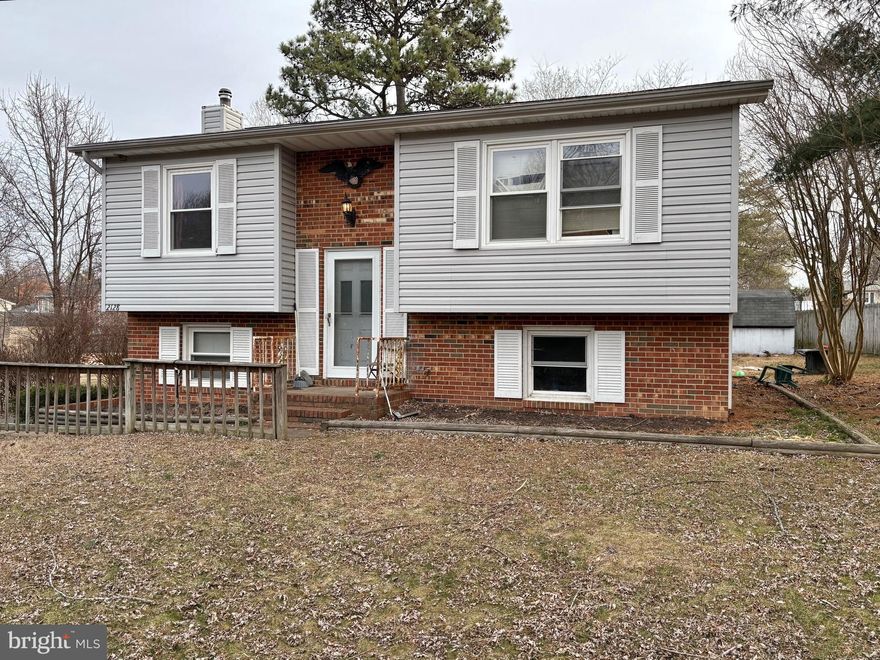 Centrally located, this split foyer home offers a perfect blend of comfort and functionality. It offers 3 spacious bedrooms, 2 full bathrooms and a NEW deck for your enjoyment. The inviting layout features a finished basement providing versatile additional space.  The exterior showcases a classic combination of brick and vinyl siding, ensuring durability and timeless appeal. Set on a generous 0.34-acre lot, there's ample room for outdoor activities or gardening. Oversized asphalt driveway parking with plenty of parking for additional recreational equipment/additional parking.  NO HOA!  Conveniently located near I95, VRE, hospitals, shopping & schools.  No professional/additional pics will be added.