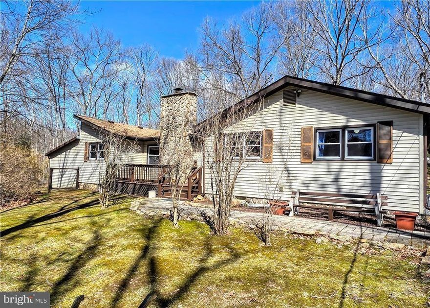 LAKE LIFE AWAITS! 4 bedroom, 2 bath ranch set on a partially wooded acre in Beltzville Lake Estates. Step inside to cathedral ceilings that open up the living space, anchored by a cozy fireplace with a coal stove insert to keep things warm all winter long. Outside, the property is set up for enjoying every season with a firepit, fruit trees, and a large garden, plus a fenced yard ready for your pups. A 2 car carport, attached shed, and additional detached shed provide plenty of storage for tools, toys, and equipment. Located in a community built for lifestyle, residents enjoy private roads that allow golf carts and 4 wheelers, along with access to a private lake, beach, and clubhouse. Adjacent to over 24,000 acres of public woodlands, you have endless opportunities for hiking, biking, and hunting right outside your door. Annual dues are $660 and include garbage service. If you have been looking for space, outdoor living, and a true lake lifestyle, this is one worth seeing. Showings begin 3.28 after open house!
