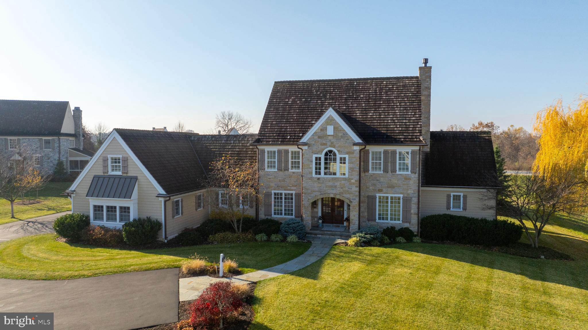 This rare, custom-built Simeral home in Manheim Township is a masterpiece of design and functionality, set on a stunning .79-acre lot. The property is conveniently located in the lovely neighborhood of The Farm within the Reidenbaugh Elementary & Manheim Township school district. For golfers, The Farm is right across the street from Bent Creek Country Club. With a bright and airy open floor plan, this home is bathed in natural light and features exquisite hand-scraped wood floors throughout. The kitchen is a chef's dream and an entertainer's paradise. It boasts a commercial-grade Thermador 6-burner gas range with a convenient pot filler, an oversized built-in Thermador refrigerator, and custom cabinetry. The expansive custom island is equipped with a microwave drawer and retractable power station, offering ample workspace and storage. Additional features include a custom cabinet pantry with a coffee station including a warming drawer, wet bar, and an electric oven. The adjoining family room impresses with cathedral ceilings adorned with exposed beams and a cozy oversized gas fireplace set within a striking stone accent wall. A custom wet bar, complete with beverage and wine refrigerators, adds convenience, hidden behind charming antique barn doors. The great room continues to awe with an additional gas fireplace, beautifully framed by a custom stone mantle and surround. A wall of windows and doors seamlessly connects this space to the breathtaking backyard, which includes a spacious covered patio and an additional open patio, perfect for outdoor gatherings. The open flow between the great room and kitchen makes this home ideal for entertaining. The main-floor primary suite is a private retreat, featuring direct access to the covered patio and a luxurious see-through gas fireplace that leads into the spa-like primary bath. The bath includes dual vanities, a freestanding soaking tub, and a walk-in shower. Upstairs, a versatile loft area complements two additional bedrooms, each with its own en-suite bath and walk-in closet. A tranquil sitting room separates the two bedrooms. Downstairs, a private stairway off the laundry room leads to a secluded office or bonus room, offering added privacy and flexibility. Impeccably designed and thoughtfully decorated, this home is the epitome of elegance and comfort. With its open layout, abundance of natural light, and endless upgrades, this dream home truly has it all. Don't miss your chance to own this extraordinary Simeral-built masterpiece!