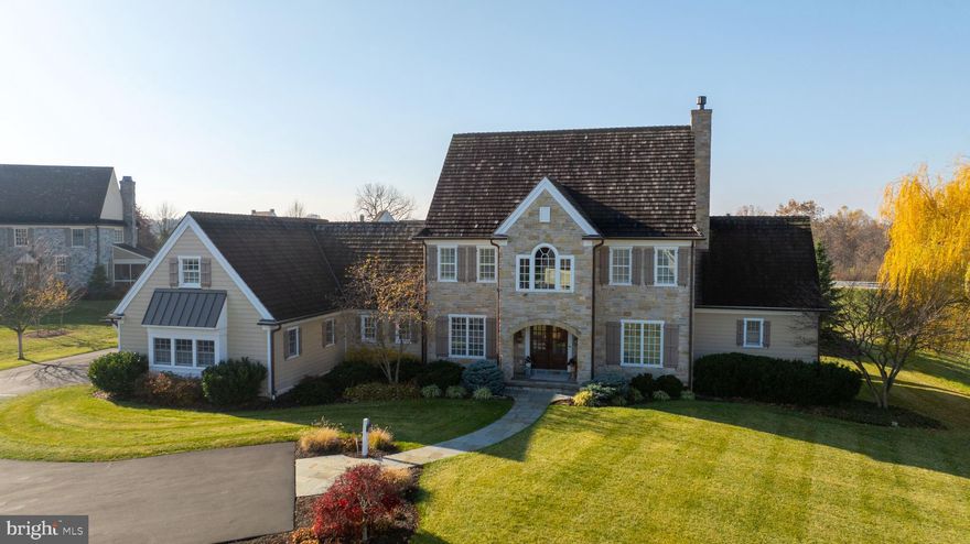 This rare, custom-built Simeral home in Manheim Township is a masterpiece of design and functionality, set on a stunning .79-acre lot. The property is conveniently located in the lovely neighborhood of The Farm within the Reidenbaugh Elementary & Manheim Township school district. For golfers, The Farm is right across the street from Bent Creek Country Club. With a bright and airy open floor plan, this home is bathed in natural light and features exquisite hand-scraped wood floors throughout. The kitchen is a chef's dream and an entertainer's paradise. It boasts a commercial-grade Thermador 6-burner gas range with a convenient pot filler, an oversized built-in Thermador refrigerator, and custom cabinetry. The expansive custom island is equipped with a microwave drawer and retractable power station, offering ample workspace and storage. Additional features include a custom cabinet pantry with a coffee station including a warming drawer, wet bar, and an electric oven. The adjoining family room impresses with cathedral ceilings adorned with exposed beams and a cozy oversized gas fireplace set within a striking stone accent wall. A custom wet bar, complete with beverage and wine refrigerators, adds convenience, hidden behind charming antique barn doors. The great room continues to awe with an additional gas fireplace, beautifully framed by a custom stone mantle and surround. A wall of windows and doors seamlessly connects this space to the breathtaking backyard, which includes a spacious covered patio and an additional open patio, perfect for outdoor gatherings. The open flow between the great room and kitchen makes this home ideal for entertaining. The main-floor primary suite is a private retreat, featuring direct access to the covered patio and a luxurious see-through gas fireplace that leads into the spa-like primary bath. The bath includes dual vanities, a freestanding soaking tub, and a walk-in shower. Upstairs, a versatile loft area complements two additional bedrooms, each with its own en-suite bath and walk-in closet. A tranquil sitting room separates the two bedrooms. Downstairs, a private stairway off the laundry room leads to a secluded office or bonus room, offering added privacy and flexibility. Impeccably designed and thoughtfully decorated, this home is the epitome of elegance and comfort. With its open layout, abundance of natural light, and endless upgrades, this dream home truly has it all. Don't miss your chance to own this extraordinary Simeral-built masterpiece!