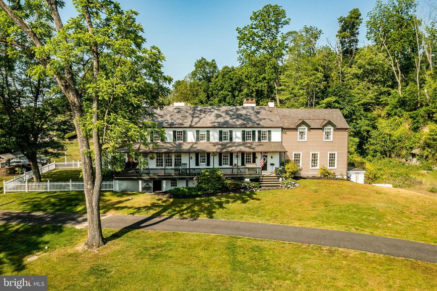 This charming, historic 1700's farmhouse home sits on 39+ acres in a tranquil setting in Worcester Township. The sweeping driveway takes you over the re-built, professionally engineered bridge overlooking the gorgeous 8ft deep aerated pond, fully stocked with Bass and Catfish! Relax on your recliners on the IPEdock enjoying the wonderful scenic views. The home has been beautifully updated throughout. The workmanship has paid special attention to maintaining and complementing the original style and era of the home throughout, with random-width pine hardwood floors, crown moldings, updated bathrooms and so much more! The kitchen features stainless steel appliances, corian countertops and custom cabinets, yet captures the old world feel with wooden beams and a huge walk-in fireplace. The back of the house has an addition behind the kitchen which is used as a breakfast/dining area. Both the kitchen and this breakfast room have radiant heated floors. Off the kitchen is the formal dining room with a fireplace beaming with natural light from the wall of windows overlooking the pond; a perfect spot for entertaining guests! This flows into the cozy den which is just off the entryway. Plus there's a  huge family room with a wood beamed ceiling, fireplace and built-in bar area. The mudroom is conveniently located off the kitchen and offers more of that farmhouse charm with brick tiled floors and walls and wooden beams.The pretty powder room, front staircase and opening the ceilings to expose the beams were updates by the current owners. To the right side of the home there is a three-story addition built by the owners, which includes a huge office on the main floor with French doors and a private IPE deck. Below on the lower level is a finished walkout basement with French doors which give access to the original basement that has storage and houses the utilities with 2 water heaters, 400 amp electric service, 5 zone A/C 6 zones for heat. The property has natural gas. The house renovation included all new systems – plumbing, electric, HVAC etc. and has a generator which powers the entire property including the house and all the outbuildings. The upper level of the addition is the master bathroom/dressing area with large walk-in closets.  The 2nd floor has 4 bedrooms, with a spacious primary suite with its own cozy fireplace and plenty of closets that leads to the ensuite bathroom with double vanity, soaking jacuzzi tub, glass shower stall and French doors that open to a Julitte balcony overlooking the lush landscape. There are 3 more bedrooms and a hall bathroom with double vanity and tub/shower combo. The main house has all newer Pella windows and doors in 2022 had a new roof including cedar shake shingles, standing seam copper, copper gutters and downspouts at a cost of $200K. Sit on your lovely covered, wrap-aroundporch and take in the beauty of your surroundings. Enjoy the renovated, inground pool with decking and a quaint cabana (also renovated) which has a kitchen area, shower/powder room and changing area making entertaining pool side a breeze with built-in outdoor brick grill ovens! Touring the rest of the property,  you'll find a large barn with 8 stalls that are totally rewired. There are 2 other outbuildings, one of which is a 40ft x 60ft Quonset Hut which currently houses the owner’s classic car collection;this building is heated and insulated. Within the last 10 years, the Quonset Hut, barn, and Lean-To have had new standing seam metal roofs and cypress siding installed.  The cabana also has a new cedar shake roof.  The Quonset Hut, barn and cabana have cupolas. The owners added a $120K dam when the pond was dredged taking it from 4ft to 8ft deep.  The land is filled with meadows and trails perfect for horse riding, hiking and observing nature and abundant wildlife. There is also a fenced pasture of approx 1.5 acres. To the right side of the property is 50 acres of preserved land. Sale includes all current acreage