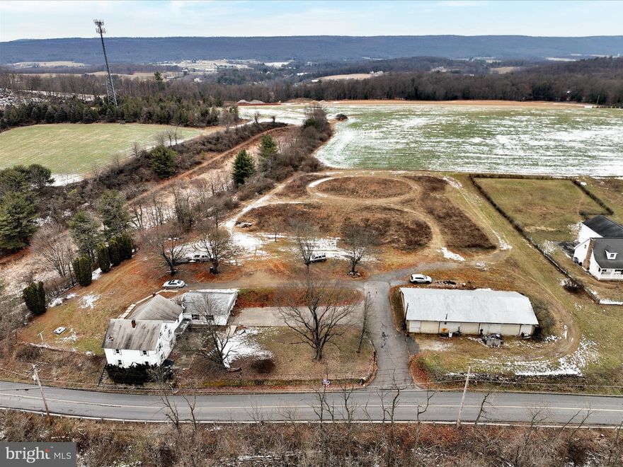 Two-unit, three-bedroom income-producing property on over 2.5 acres with an attached two-car garage! Live in one side and rent the other, or use both as an investment. One unit features electric heat, while the other is equipped with oil heat. Each unit includes a walk-up attic for extra storage and is separately metered for electricity.  A detached, oversized three-bay garage offers additional income potential. This home is nestled in a peaceful country setting, just minutes from town, with plenty of off-street parking. This one won’t last long—add it to your portfolio before it’s gone!