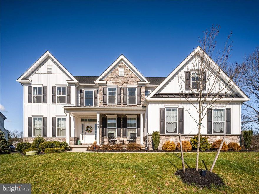 Magnificent home located on a private cul-de-sac in The Stonegate Reserve in Skippack Township. Step through the covered front porch and you are welcomed by the front door surrounded by glass windows panels.  Hardwood floors on the first floor greet you as you enter the two-story foyer with stunning chandelier.  The formal living room is on the left and formal dining room on the right with tray ceiling and stunning light fixture.  The main-floor office, perfect for remote work or study is highlighted by French doors, recessed lighting, center ceiling light fixture, and window view of the backyard scenery.  The Gourmet kitchen features beautiful Quartz countertops including large island with pendant lighting, recessed lighting, under counter lights and outlets, tile backsplash, pantry closet, farm sink, exhaust hood that vents outside, all SS appliances including refrigerator, gas range with oven, built-in second oven, microwave and dishwasher.  Just off the kitchen is a roomy breakfast area that extends into an additional morning room, perfect space for relaxing.  The family room features floor-to-ceiling stone fireplace, stunning wall-of-windows with motorized custom blinds, and breathtaking coffered ceilings with two delightful light fixtures.  The fireplace is currently wood burning but can easily be converted to gas. Powder room, mudroom area with two large closets and access to 2 car garage complete this floor.  Pamper yourself in the primary en-suite featuring tray ceiling, a large luxury walk-in closet, additional walk-in closet, separate large sitting room, and luxurious bathroom with garden soaking tub, double sinks, enclosed glass shower & separate toilet stall. The additional bedrooms are also on this floor.  Bedroom #2 is also en-suite and has double closet.  Bedrooms #3 and #4 also have large closets and are connected by a full bath that has dual vanity sinks with separate tub/toilet room for added privacy.   The finished basement has spacious finished area that includes ½ bathroom and laundry room with washer, dryer, cabinets and utility closet. Plenty of room to entertain or relax!  Also, nicely sized unfinished area for storage.  Heating is 3 zoned/one on each floor.  Two furnaces and two AC units make this very efficient with the newer construction insulation.  Bedrooms and morning room are pre-wired for ceiling fans if you desire.  Wonderful neighborhood with sidewalks.  All this in the Award-winning Perk Valley School District!
