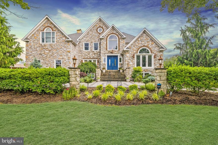 Welcome to an exquisite retreat at 170 Brochant Circle, Blue Bell, PA. This sophisticated home, boasting approximately 6,500 square feet of luxurious living space, is perfectly situated on a sprawling 27,434 square-foot lot. Featuring five generously-sized bedrooms and seven bathrooms—comprising five full baths and two half baths—it offers an abundance of space and comfort for all.

Step into the heart of elegance, where expansive living areas flow effortlessly with high ceilings, multiple fireplaces, and exquisite finishes throughout. The gourmet kitchen is a chef’s delight, featuring premium Thermador appliances, a spacious island adorned with leathered granite, and a butler’s pantry. Adding to its charm, the kitchen includes a soapstone sink that complements the sophisticated design. The elegant touch of travertine floors extends into the mudroom and laundry room, adding timeless sophistication. A coffee bar with matching leathered granite enhances both functionality and style, perfect for starting your day.
The library/den exudes warmth and refinement with custom maple-paneled walls, a vaulted maple coffered ceiling, and is equipped with Hunter Douglas Solar shades for optimal light control and privacy. A captivating glass-inspired temperature-controlled wine vault stands as an elegant focal point in both the family room and office, featuring solid walnut countertops and shelves, perfect for showcasing your collection to guests. Throughout the home, the primary bedroom, second-floor hallway, and family room are enhanced with hand-scraped Brazilian Cherry floors, adding rich elegance and warmth.

The primary bath boasts bamboo flooring, creating a serene sanctuary, while the Jack and Jill bath features elegant quartzite countertops. All other bathrooms are adorned with granite countertops, ensuring a consistent theme of luxury and durability. The approximately 2,000 square feet of finished basement space offers versatile options for entertainment, relaxation, or a personal gym, all graced with luxury vinyl plank flooring for both style and durability.

Outdoor spaces include manicured gardens and a serene patio covered with 1-inch thick outdoor porcelain pavers, and an inlaid basketball court at the top of the driveway. Discover unparalleled sophistication and a lifestyle of ease in this remarkable Blue Bell estate, where every detail enhances refined living, offering a seamless blend of luxury and comfort.