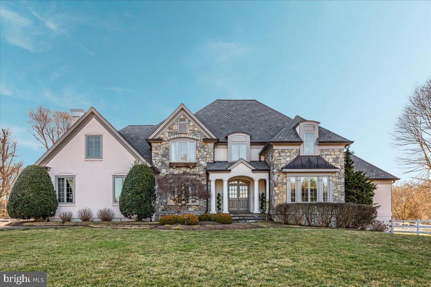 Crosswinds Farm is an extraordinary 9.49-acre equestrian estate designed & built by renowned John Neufeld Architects. This French country-style masterpiece, crafted in stone and stucco, seamlessly blends elegance and functionality, offering a luxurious retreat for both horse enthusiasts and refined country living.  The kitchen is a perfect blend of elegance and functionality, featuring custom white cabinetry that offers abundant storage and timeless beauty. The granite countertops provide expansive counter space with both an island & a peninsula offering counter seating.  Adjacent to the kitchen, a charming breakfast room features French doors that lead to a serene patio, offering a seamless transition between indoor and outdoor dining. The doors flood the space with natural light, creating an airy and inviting atmosphere perfect for enjoying meals with a view.  The generously sized laundry room provides even more cabinetry & counter space, making it a fabulous prep area for entertaining. The inviting family room is seamlessly connected to the kitchen & is designed for comfort and style.   A cozy fireplace flanked by custom built-in bookshelves serves as the focal point, creating a warm and welcoming atmosphere.  The grand formal dining room features a custom-commissioned mural showcasing the estate’s breathtaking landscape & a hidden fox, while the formal living room and the gorgeous oak-paneled study add a touch of timeless sophistication. The five-bedroom home boasts an impressive primary suite on the second level, complete with two private sitting rooms & two walk-in closets with room to expand.  The luxurious primary bath features dual vanities, a deep tub with jets, separate shower & private water closet. The "Princess Suite" features beautiful architecture & an ensuite bath. Four bedrooms, all with hardwood floors, & 3 full baths in total are located on the upper floor.  The fully finished lower level is an entertainer’s dream, featuring a wet bar, fireplace, recreation room, brand new infrared sauna (can coney) & billiards table (can convey) that seamlessly flows to a charming sunken patio with a brand-new hot tub.  Additionally, the lower level features a large fifth bedroom & a fourth full bath.  Equestrians will delight in the stunning Morton eight-stall barn, designed for the utmost comfort and care of their horses. Complete with swing out feeders, heated tack room, laundry room, hot/cold wash stall, & hay loft, the barn ensures top-tier functionality. The barn was designed with exquisite attention to detail & features a ventilation fan & three cupolas that complement the natural airflow, providing an optimal temperature year-round. The barn also features five expansive pastures with classic three board white fencing & a 100x200 bluestone/rubber riding ring, perfect for dressage, hunters or jumpers, complete with a full-width arena mirror!  Your favorite spot will be the incredible covered front porch of the barn overlooking the stunning property. Additional features include new roof & gutters in 2019, new Pella windows in 2024, oversized 3 car garage, 4 zone heating on main & upper floors, central vacuum & abundant storage room.  Whether you seek a luxurious state-of-the-art equestrian facility, or a magnificent estate to call home, Crosswinds Farm offers an unparalleled lifestyle.  Located just minutes outside of the charming town of Clifton!