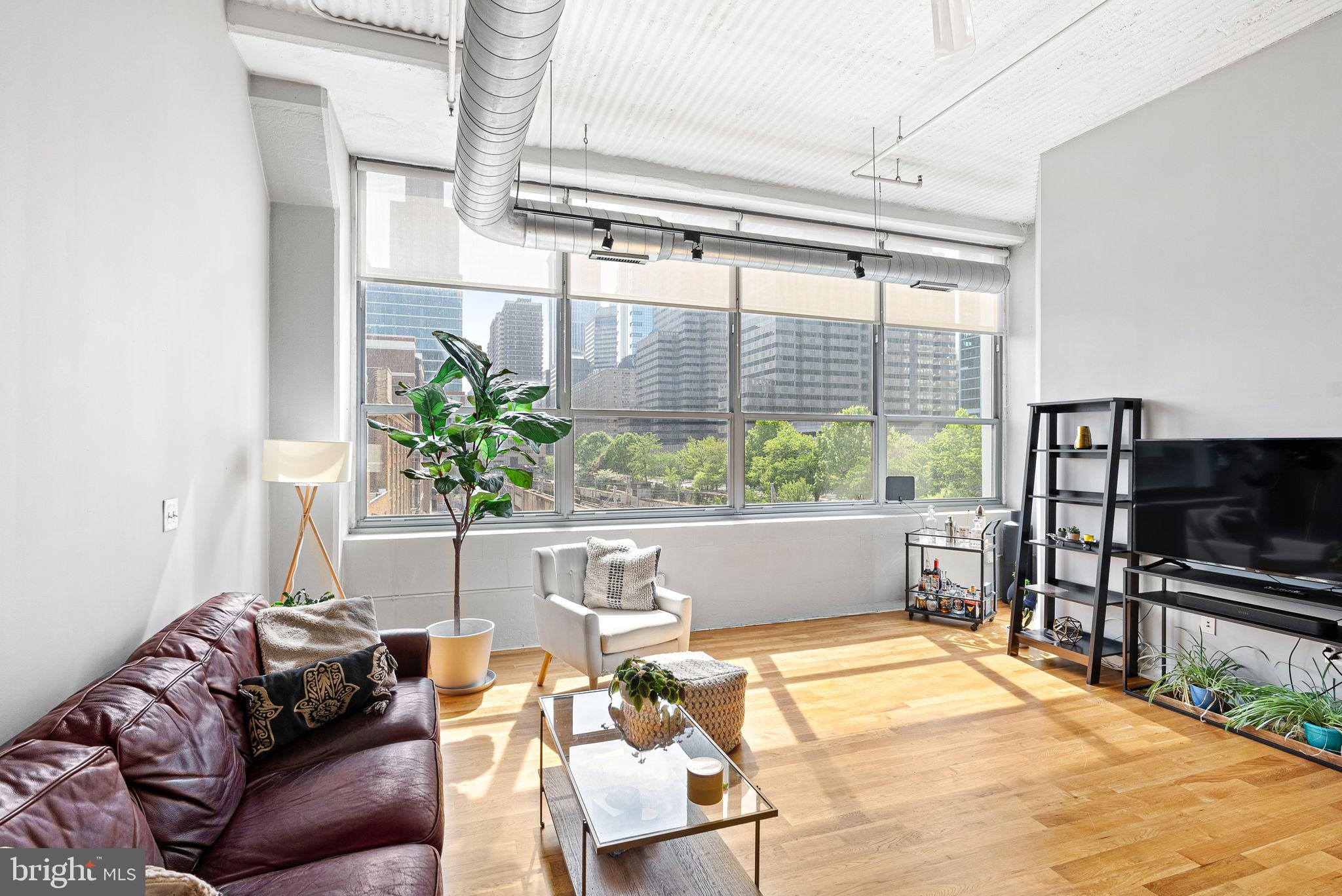 Prime loft-style living with incredible views and deeded parking in Logan Square!
Welcome to this spacious 1 bed, 1 bath loft condo in the Larkin Building located at 2200 Arch Street. This east facing unit has incredible, unobstructed views of city and offers everything you could want in a unit and building from top notch amenities to one of the best layouts in the building. The open layout features hardwood floors throughout, massive windows (complete with custom shades), a spacious updated kitchen, and high ceilings. The space is divided in the middle leaving a large bedroom with enough additional space for a seating area and an office set up. The bedroom area also features a large, walk-in closet with multiple levels of custom shelving, giving you ample storage space, rare for a condo. The full bath is nicely appointed with vanity and tub/shower combo. This unit also features a separate coat closet and a utility closet housing your own washer and dryer. The deeded parking space is accessible via the parking garage which also offers a bike storage area.
In addition to parking, this well-maintained building has multiple elevators, a 24-hour front desk, a conference room, and a fantastic fitness center with state-of-the-art equipment. Conveniently located in Logan Square, you're just steps away from amenities like Trader Joe's and Giant, attractions like the Philadelphia Museum of art and Franklin Institute, and amazing bar/restaurants in Rittenhouse Square. Easy access to 30th Street Station makes commuting easy and the ever popular Schuylkill River Trail is right outside your door.