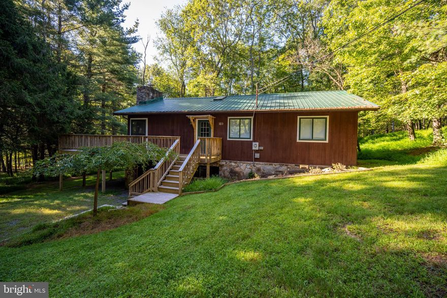 Tastefully Remodeled Log Cabin in Sky Valley - This 3 bed, 2 bath lake access cabin sits on a wooded lot in the heart of Sky Valley. Fully updated with new decking, floors, appliances, and bathrooms. Open layout anchored by a massive stacked-stone fireplace plus a wood stove in the rec room. Oversized one-car garage for all your gear. Easy golf cart ride to the sandy beach lake access. HOA offers 157 dock slips, so the wait for your own could be short. Sold turnkey/fully furnished! If you want a rustic Deep Creek getaway with unbeatable lake access and all the modern comforts of home - this one checks the boxes. Call today for your private showing!