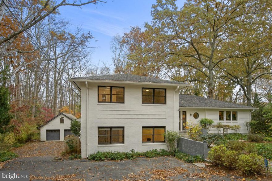 NEW YEAR NEW PRICE! Tucked into a beautiful neighborhood and set back from the road, this stunning 6-bedroom, 4.5-bath residence checks every box for the buyer seeking quality craftsmanship, a quiet and private setting, and a floor plan designed for gracious living and entertaining.  The outdoors is seamlessly blended into the fabric of this home, which has been masterfully renovated with wide cased openings, custom built-ins and exquisite molding and trim.  
Enhanced with hardwood flooring and banks of windows and glass doors, sunlight permeates the primary rooms, which include a gorgeous chef’s kitchen with maple cabinetry and an island, a stunning dining room with built-ins, and a beautiful living room with a slate fireplace flanked by custom floor-to-ceiling cabinets.  The dining room and living room offer breathtaking views of the expansive lawn and treed landscape, and both open to a deck spanning the residence.  A powder room completes the main level.  
The upper-level features 3 large bedrooms and 2 full baths.  The private owner’s suite offers a spacious walk-in closet, two additional closets, a renovated full bath and a luxurious bedroom retreat with a dramatic lofty ceiling and a bank of windows overlooking the grounds.  
Ideal for the modern household, the driveway accesses a mudroom on the lower level.  This level features 3 more bedrooms and 2 more full baths.  At every turn this home surprises with its attention to detail and abundance of space.  Fully carpeted, lower level two includes a spacious recreation room with built-in bookcases, and it opens to a covered flagstone patio.  With its private access, the large home office on the opposite side is ideal for the professional.  There are multiple areas for household storage and there is every amenity for residents and guests.  
Step outside to the oversized, detached two-car garage, which is finished with a second-floor loft.  Skylights continue the theme of abundant natural light that defines the character of this home, with the loft offering a perfect setting for another home office, an artist’s studio or a child’s dream playroom.  There is even a barn with an enclosed pen suitable for raising small farm animals or to store yard equipment. 
Sited on a spectacular lot with a large expanse of lawn and surrounded by a variety of trees and landscape, this property backs to the Northwest Branch trails.  The privacy and quiet offer no hint of the easy access the home has to downtown Silver Spring and DC.  A perfect blend of open living space and inviting private accommodations, this wonderful home is a celebration of style and function, with an unmistakable nod to the best that nature has to offer.