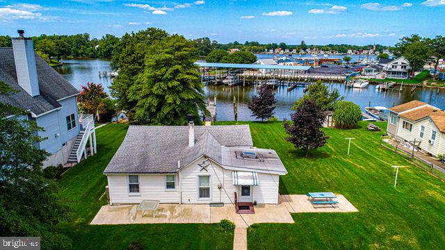 THIS CHARMING WATERFRONT COTTAGE ON A DOUBLE LOT IS LOCATED ON HOPKINS CREEK AND MINUTES AWAY FROM THE CHESAPEAKE BAY. FOR OUTDOOR & WATER ENTHUSIASTS THE PROPERTY INCLUDES A PRIVATE PIER AND STONE BULKHEAD THAT PROVIDES DIRECT ACCESS FOR BOATING, FISHING, SWIMMING, PERSONAL WATERCRAFT, AND SUMMERTIME FUN. NEARBY MIDDLE RIVER YACHT CLUB, SEVERAL MARINAS, WILSON POINT PARK, ROCKY POINT PARK & BEACH, AND SEVERAL RESTAURANTS. 9 FT CEILINGS. FRENCH DOORS LEAD TO THE LIGHT FILLED FAMILY ROOM FULL OF CHARACTER W/KNOTTY PINE WOODWORK, WINDOWS, AND SLIDER TO REAR DECK THAT OVERLOOKS A LEVEL YARD WITH A SERENE VIEW OF THE WATER. KITCHEN OFFERS ALL OF THE TYPICAL APPLIANCES, OAK CABINETRY, SKYLIGHT, VAULTED CEILING, PANTRY, AND BREAKFAST BAR. SEPARATE DINING ROOM. LIVING ROOM IS SPACIOUS WITH A UNIQUE WOOD BURNING STOVE. PRIMARY BEDROOM AND BEDROOM 2 ARE GOOD SIZED. BASEMENT IS UNFINISHED INCLUDING A WASHER/DRYER, WALK-UP TO REAR YARD, UTILITY SINK, AND PLENTY OF STORAGE. 1 CAR GARAGE & 2 CAR CARPORT. 2 SHEDS. CLOSE PROXIMITY TO MAJOR THOROUGHFARES, SCHOOLS, AND SHOPS.