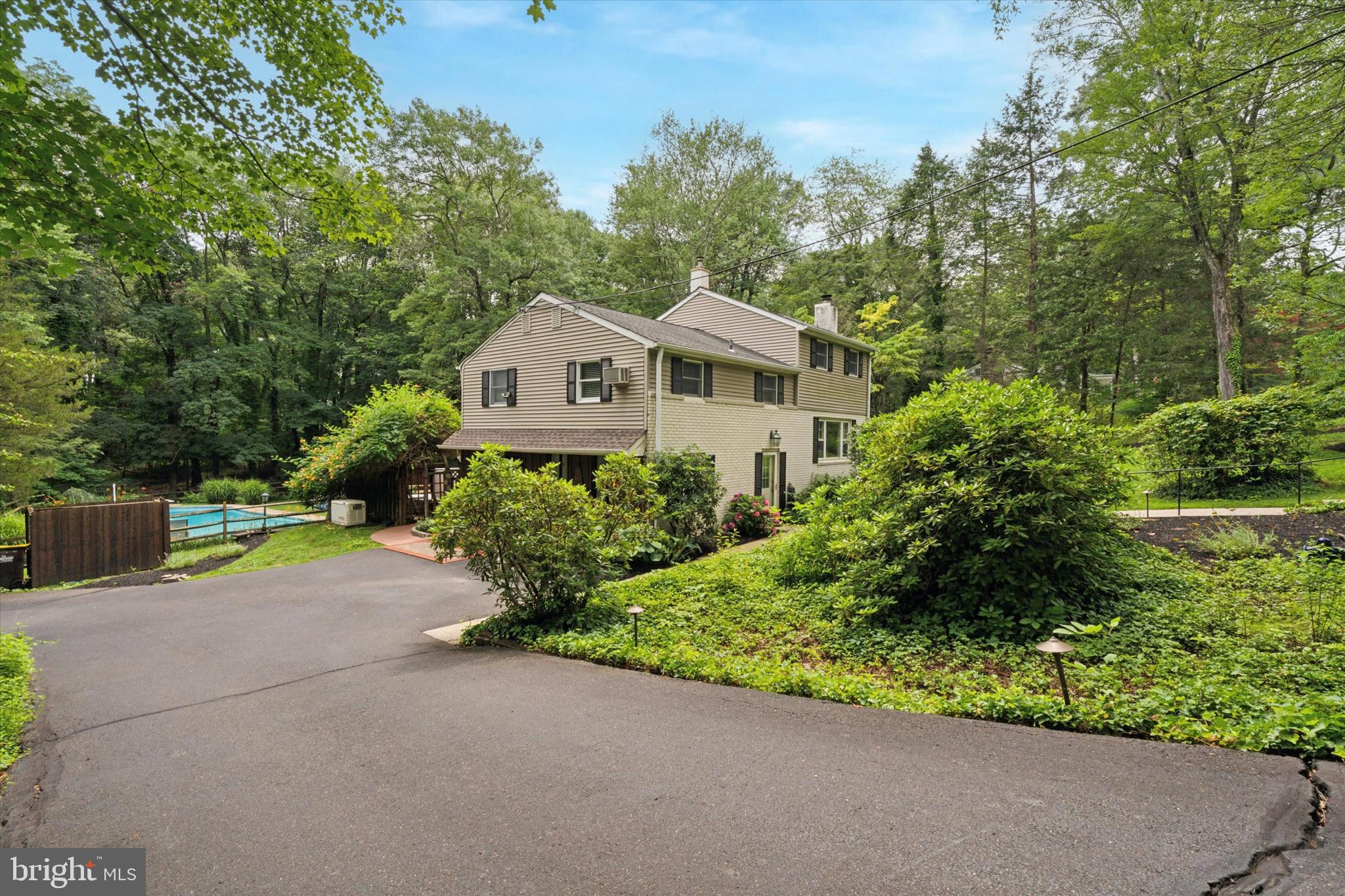 73 Tower Hill Road is nestled into the Tower Hill subdivision, on a beautifully wooded street tucked in just off Easton Road. You’ll have your own private retreat that’s conveniently located just a short walk into Doylestown Borough where you’ll find countless dining, shopping and entertainment options. Outdoor relaxation and entertainment throughout the year will be a highlight of owning this home. In the summer, you’ll have a heated in-ground pool to cool off and relax in, an oversized deck with a retractable awning to shade your late afternoon cookouts, and a patio below for extra entertaining space. Cool evenings and snow days can be enjoyed from the hot tub on the patio, and in all seasons, nature will surround you. Inside the home is a cozy and versatile floor plan with several options to customize the layout to your liking. Entering the home off the driveway, you’ll enter a space that can be used as a sitting room, home office or game room, and there is a sliding door out to the patio from this room. There is also a sitting room, laundry area with access to the crawlspace for storage, and a powder room and separate stall shower (this space could easily be modified to create a 2nd full bathroom. On the main level are a living room with a propane log fireplace, kitchen with peninsula and a dining area with a sliding door out to the deck. From here, you have a birds eye view of the pool, manicured property, and adjoining green space. On the first upper level are a hall bathroom and two bedrooms. Currently one of the bedrooms is shown with a separate sitting area (this space could easily be converted to a 4th bedroom). On the upper level is the oversized primary bedroom, which can be furnished in a number of ways to create your own end-of-the-day retreat. There are many mechanical upgrades to the home, some of the highlights are a whole home backup generator to ensure lighting and comfort in all weather, landscape lighting to illuminate the grounds and the home, newer well pump, newer oil tank, and Hunter Douglas blinds throughout much of the home. With immediate access to Route 202 and 611 and a very short commute to Doylestown Hospital, the location is prime while still having a “tucked away” feel. Come visit 73 Tower Hill Road and find your way home!