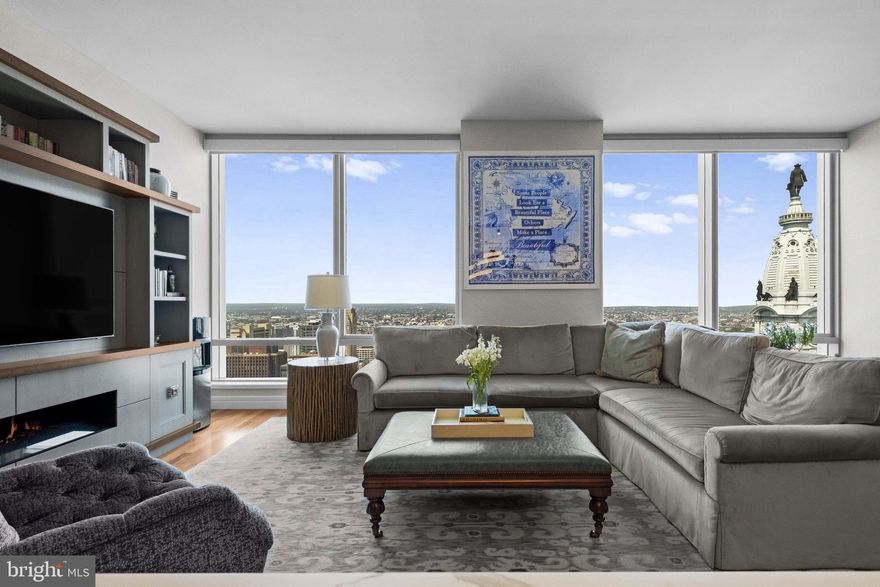 Experience unmatched luxury living in this expansive 2,115 sq. ft. residence with breathtaking open city views at the Ritz Carlton Residences. A grand entry foyer welcomes you into the home defined by soaring 10-foot ceilings, floor-to-ceiling windows, and incredible natural light throughout.  At the heart of the home is an open chef’s kitchen featuring stainless steel appliances, quartz countertops, and abundant storage, flowing seamlessly into a large living area with a built-in media center and a dining room ideal for large gatherings. The thoughtfully designed split two-bedroom layout ensures privacy and flexibility, perfect for both everyday living and entertaining. The primary suite is a true retreat, with dual walk-in closets fully customized and built out for optimal organization. Indulge in the rare luxury of his-and-hers separate bathrooms, each adorned with marble tiling, polished chrome hardware, and sophisticated finishes. The second bedroom, currently shown as a den space can easily be used as a true bedroom space and is complete with a large closet and en-suite bath. Every detail in this residence blends elegance with functionality, offering an unmatched living experience in the heart of the city.  Additional features include an extra-large laundry room with storage, Lutron electric shades, and central heating and cooling, and 1 parking space. The world class Residences at the Ritz amenities include a 24 hour doorman and concierge, valet parking, town car services, fitness center, indoor swimming pool with a jacuzzi, private locker rooms and yoga area, as well as a theatre room, outdoor entertaining area with a kitchen area, resident lounge, and dog park.