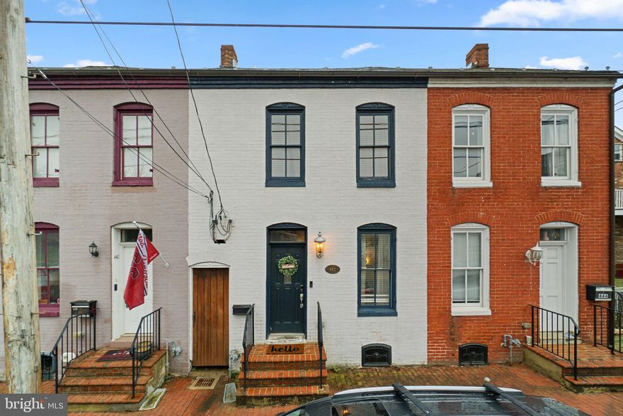 Charming and spacious 1860s home —perfectly situated just blocks from everything downtown Frederick has to offer.  A full bathroom, dining space, and comfortable living room are all located on the main level. The main-level kitchen features  sleek granite countertops and stainless steel appliances. On the second level, you'll find the primary bedroom with an en suite bath featuring tiled floors, a classic clawfoot tub, and a separate shower. A second bedroom offers access to a private balcony, while the third level hosts a spacious loft-style bedroom with charming exposed brick. An additional full bathroom is also located on the second floor. Hardwood floors throughout. 2 parking spaces located out back for easy worry free parking.