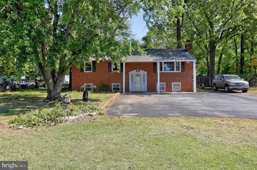 This lovely brick front 5-bedroom home is perfectly situated on a spacious parcel of land, offering the ideal blend of comfort, functionality, and versatility.  A true standout feature is the oversized 3-car garage located at the rear of the property. Whether you're a car enthusiast, hobbyist, contractor, or need serious workspace and storage, this setup is ready for it all. Bring your boat, trailer or multiple vehicles, there is still plenty of room to spare.  Inside, the home offers generous living space with five well-appointed bedrooms that can also serve as a home office, fitness room, guest suite or craft room to fit your lifestyle needs. The spacious eat-in kitchen features abundant cabinet and counter space, making meal preparation and entertaining both easy and enjoyable.  Natural light fills the home, creating a warm and inviting atmosphere throughout. Step outside and enjoy the mature trees, added privacy and endless possibilities that come with a larger lot—ideal for entertaining, gardening, recreation, future expansion, or simply enjoying your own space. Please note: The garage can be accessed from the gravel road.