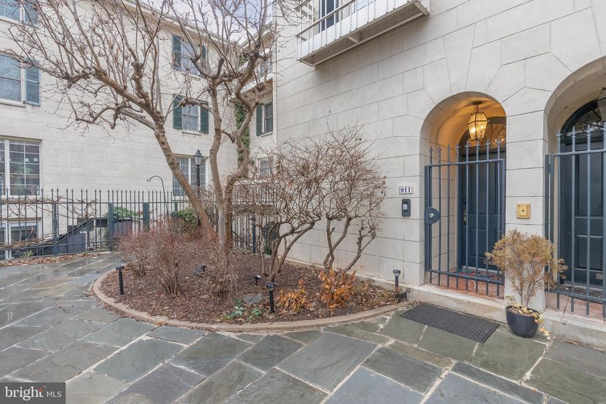 Bright, airy, and overflowing with architectural details, 911 Bonaparte Ct is a luxurious townhome nestled in a hidden enclave of private residences in the heart of Washington Square West. This expertly renovated property offers 3 bedrooms, 2.5 bathrooms, a deeded parking spot right out front, multiple outdoor spaces, and placement within the top-rated McCall School catchment. You're welcomed by an idyllic courtyard, with mature trees and manicured shrubbery that bloom during the warmer months. A gated threshold leads inside, where a mezzanine-style entry hall with hardwood floors and a coat closet creates a grand first impression, showcasing views of the lower level and the commanding center staircase. Natural light pours into this open layout from towering southwest-facing windows. Stepping down, you'll find a sunlit dining room benefiting from soaring 2-story ceilings. The relaxed family room is open to a sleek kitchen fitted with two-tone cabinetry, brass fixtures, black counters, a subway tile backsplash, and high-end appliances, including a Miele Induction cooktop and paneled refrigerator. Sliding doors lead to a paver patio, which also has access from the courtyard—perfect for entertaining. On the main level, built-in bookcases and a bathroom with a storage room sit off the staircase. The living room has a fireplace, a balcony, and an office alcove that can be hidden by drapes. The home's second level has two large bedrooms and a gleaming full bathroom adorned with herringbone tile, wall-mounted fixtures, a pair of intricate sink vessels, and heated floors. It also has the laundry and a pocket door that allows the soaking tub, shower, and toilet to be used privately from the vanity. Topping off the home is a hotel-like primary suite. It boasts a spacious bedroom with a fireplace, a dressing room with bespoke closets, a reading nook, a balcony, and another luxurious bathroom with heated floors, a double vanity, and a glass-enclosed shower. Utilities include central A/C, electric forced-air heat, and electric hot water, making the home gas-free. In addition to everything inside, this fantastic location earns a Walk Score of 97! It has a friendly, residential feel yet is only steps from Center City. Dining for all palates, shopping for all tastes, popular markets, and sprawling parks are within a few blocks. Neighboring Rittenhouse Square has lots to explore, plus there's easy access to Jefferson Hospital, Pennsylvania Hospital, and public transit. Schedule your tour today!