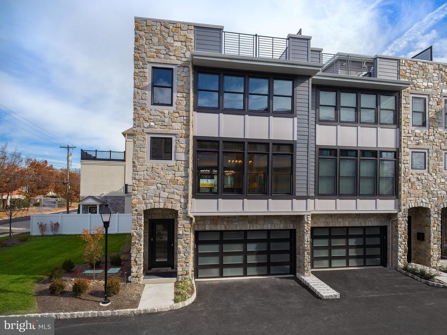 Introducing the last available end home in the heart of Devon, where 7 luxury townhomes all with elevators are being built. Conveniently located just minutes from shopping, dining, and 2 train stations, this exquisitely appointed home is a true gem. Step inside to discover a main floor featuring a foyer, garage access, mudroom, and a versatile flex space with a full bathroom that can serve as a private guest suite, home gym, or office. The main level boasts 10' soaring ceilings and an open floor plan, highlighted by a spacious great room with oversized windows and a 42" gas linear fireplace with built-ins. The heart of the home is the kitchen, equipped with custom cabinetry, a 12-foot, double sided island with lots of storage, quartz countertops, Jenn Air stainless steel appliances, a hood vent, and custom lighting. Additional features on the main level include a pantry, wet bar, and dining area. Upstairs, the owners' retreat awaits, offering ample space, an enormous custom closet, and a private en-suite with a double sink vanity, water closet, and walk-in shower. Two generously sized bedrooms, a hall bathroom, and a laundry room with cabinetry complete the bedroom level. For added convenience, an elevator takes you up to the 4th-floor loft, providing extra living space and versatility, along with a wet bar and a full bathroom. The highlight of this home is the 400 sq ft rooftop terrace, enhanced with an outdoor kitchen and an exterior fireplace, perfect for entertaining or relaxation. Situated within a stroll's reach of convenience, this charming abode boasts an enviable location—just steps away from two train stations, inviting cafes, delightful coffee shops, and renowned establishments like Whole Foods, Terrain, Anthropologie, and the Devon Horse Show. Embrace the ease of a vibrant neighborhood at your doorstep.  Get ready to move in this year and enjoy the luxurious lifestyle this home offers. Don't miss out on this incredible opportunity!  **Some photos have been virtually staged.