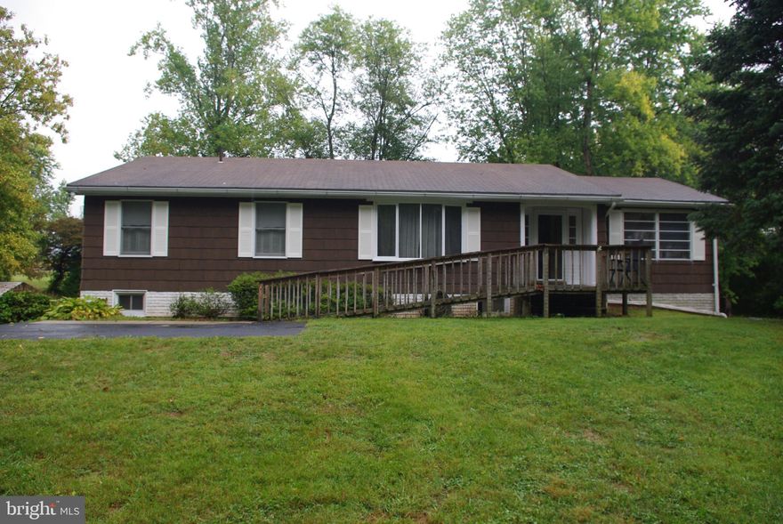 Welcome to this solid 1977 ranch-style home, nestled on 3.02 +/- acres of quiet land on Neck Road in Williamsport, MD. Offering the perfect balance of seclusion and convenience, this 3-bedroom, 2-bathroom home on the main level boasts peaceful living with modern comforts.

The property features a full walkout basement that is mostly finished, providing additional living space and includes a third bathroom for added convenience. Surrounded by trees in the front and a farmer's field at the rear, the home offers privacy on all sides, making it a quiet retreat from the hustle and bustle.

Outdoor features include a spacious rear deck, a large lawn perfect for recreation, a shed for storage, and a durable steel carport. The property is easily accessible via an asphalt driveway, and although the setting feels remote, you are just minutes from the amenities of Williamsport and surrounding areas.

This property is a rare find for those seeking privacy, and proximity to modern conveniences. Don't miss the opportunity to make it your own!